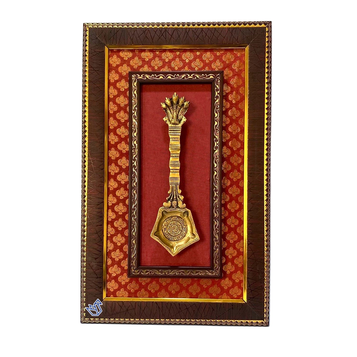 Decorative gold spoon in a brown and red frame on a white background