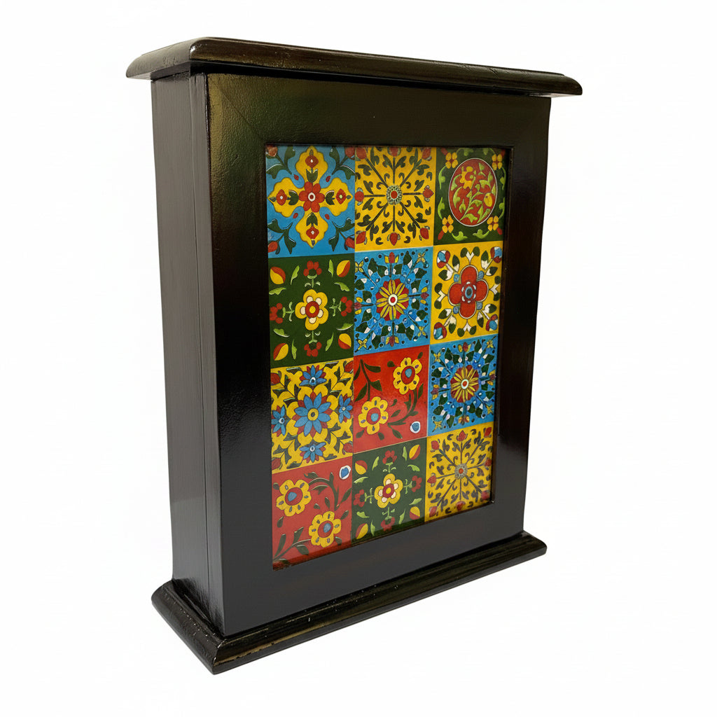 Small black cabinet with colorful floral patterned door on a white surface.