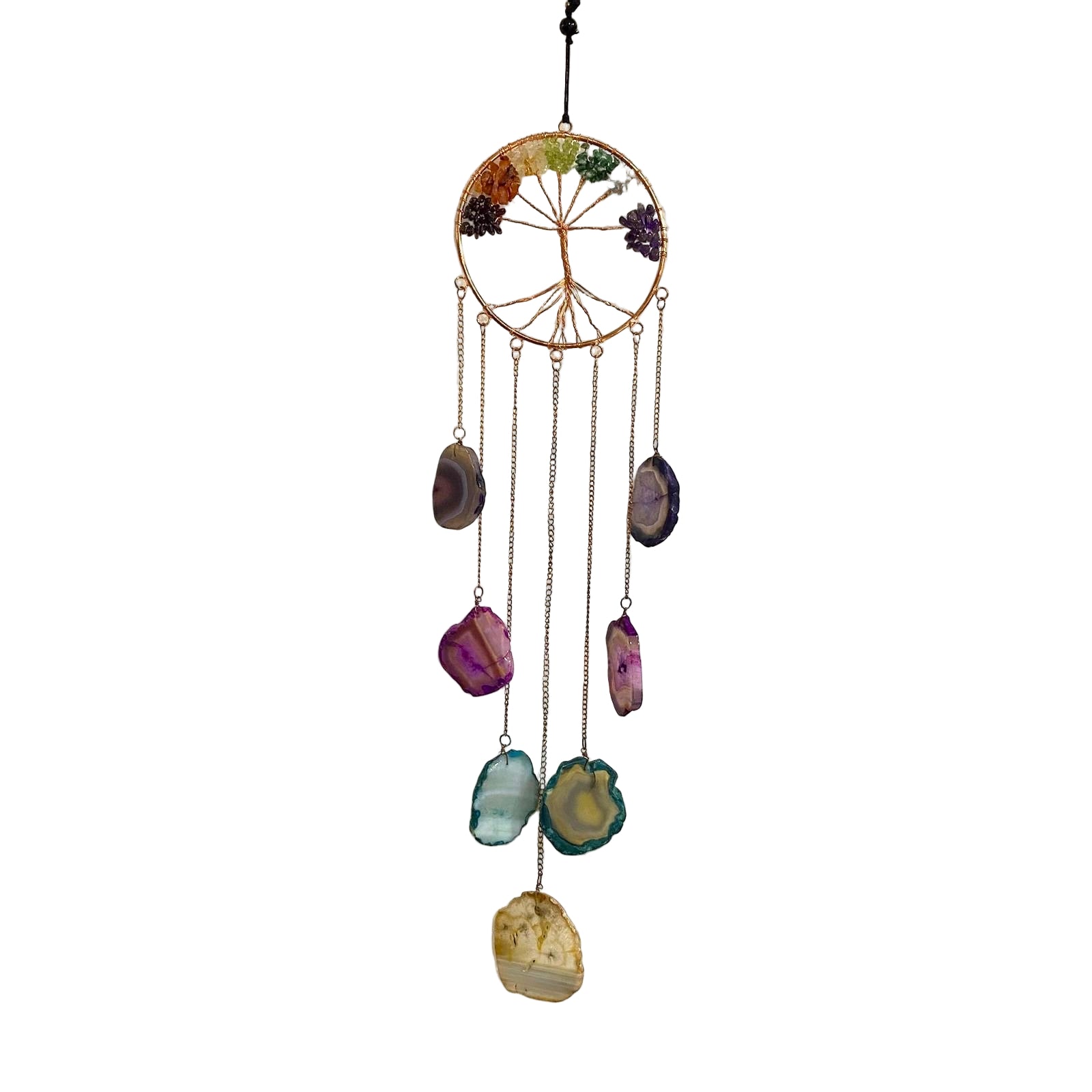 Decorative wall hanging with a circular design and colorful stones on a textured white wall.