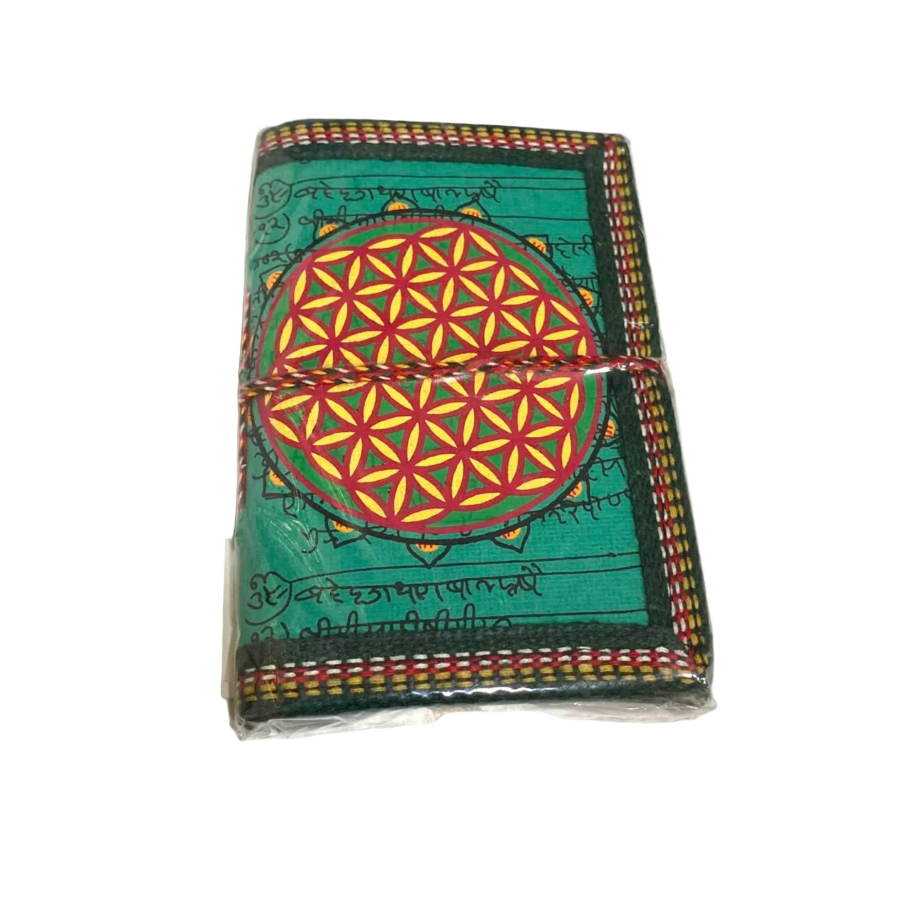 A small square notebook or journal wrapped in clear plastic, featuring a green cover with a large multicolor geometric flower design in the center and script-like patterns around the border.
