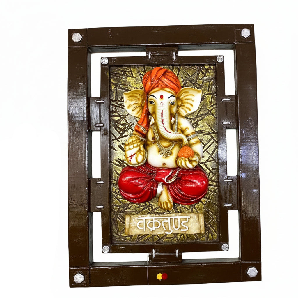 Decorative wall art featuring an elephant god figure with a brown frame on a white wall.