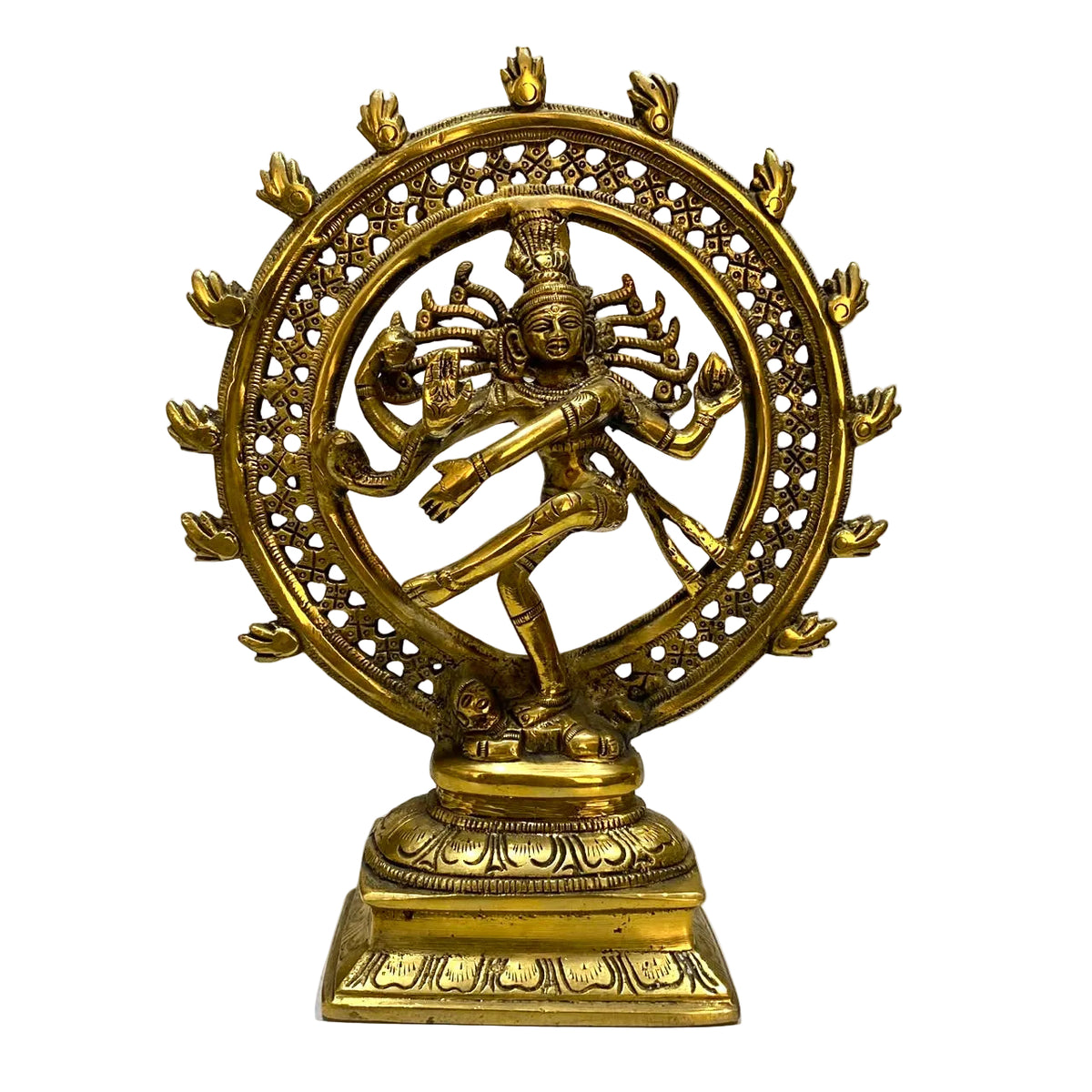 A brass Nataraja statue depicting the Hindu deity Shiva in a dancing pose within a circular flame mandala, mounted on a tiered lotus base.