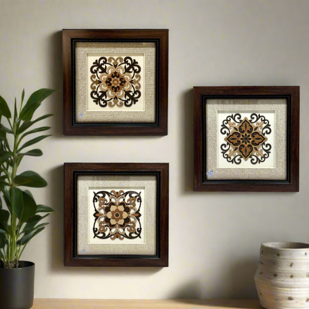 Three decorative wall art pieces with intricate patterns in wooden frames on a white background