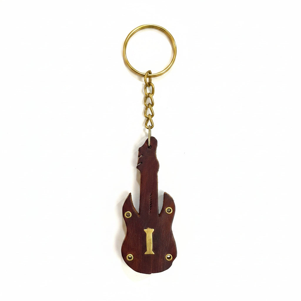 Guitar-shaped keychain on a textured white background