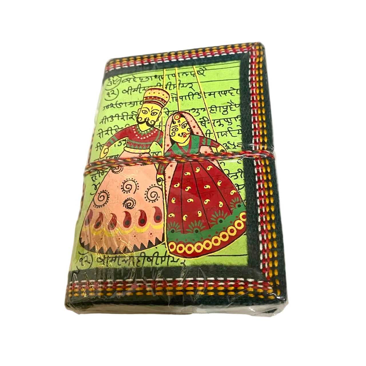 A small rectangular decorative box or notebook wrapped in clear plastic, featuring a hand-painted style illustration of a couple in traditional clothing on a light green background with black script and multicolored borders. The item is tied with a braided cord and photographed on a white surface.