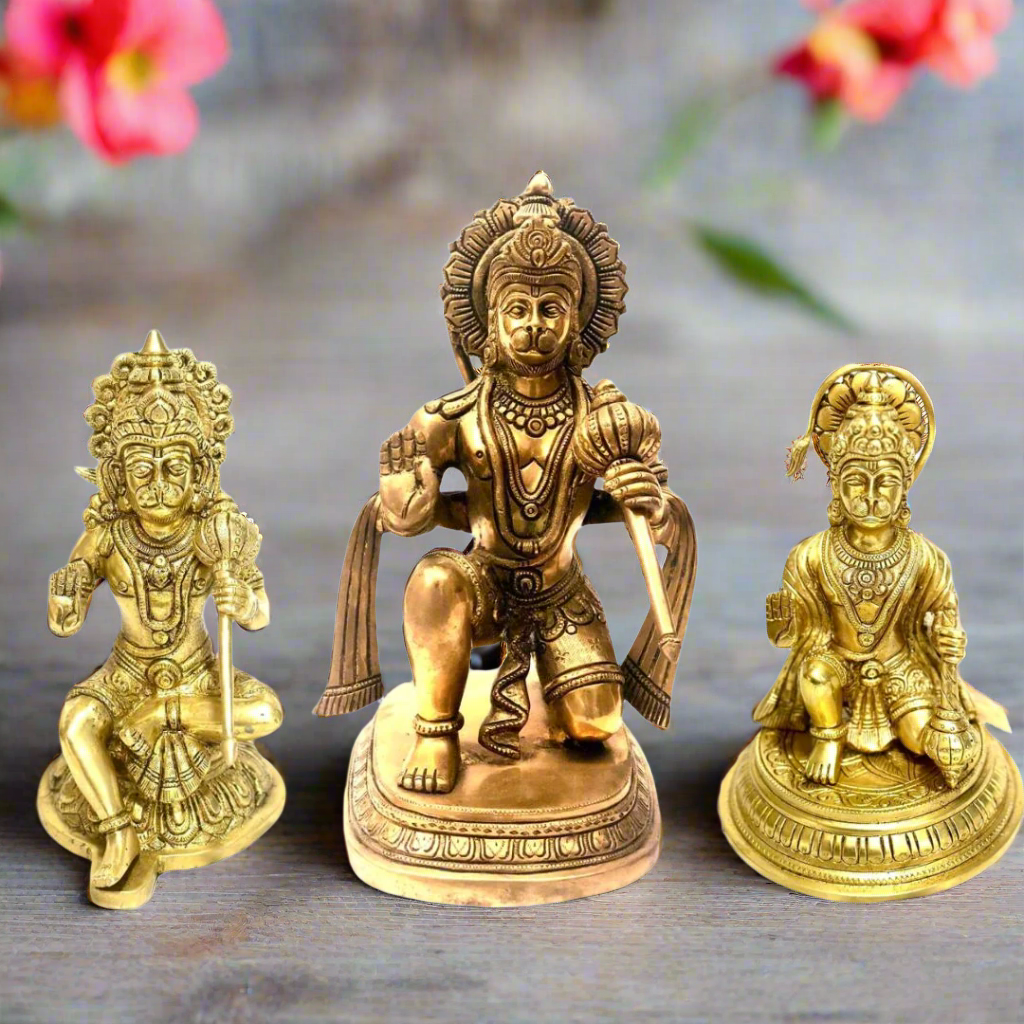Three gold-colored statues on a white background