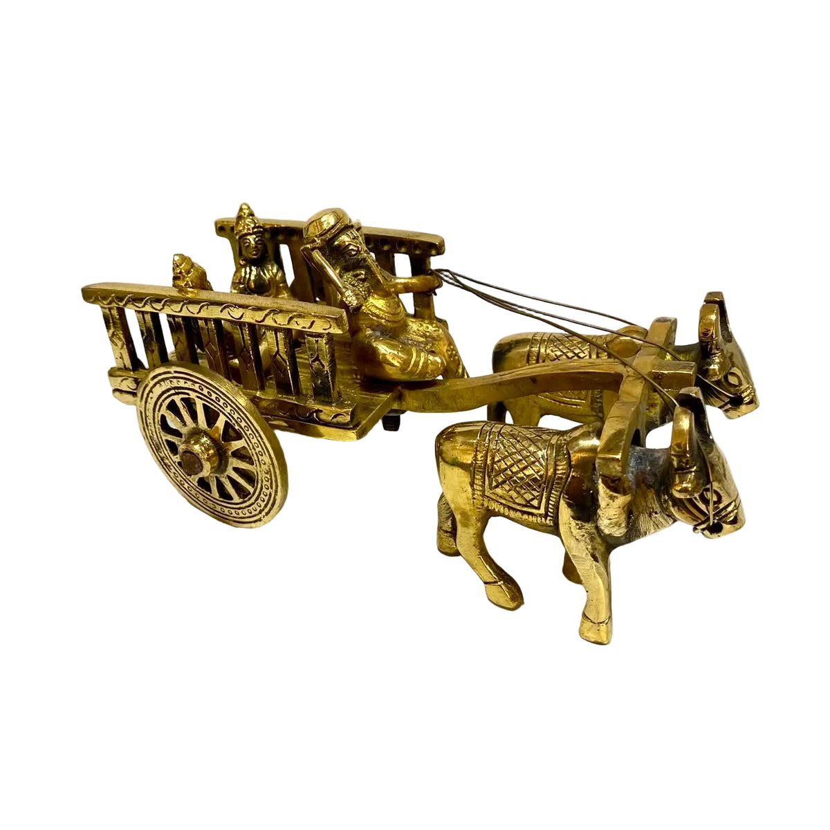 A small brass decorative cart figurine with two oxen, a driver, and passengers, photographed on a white surface against a plain light background.