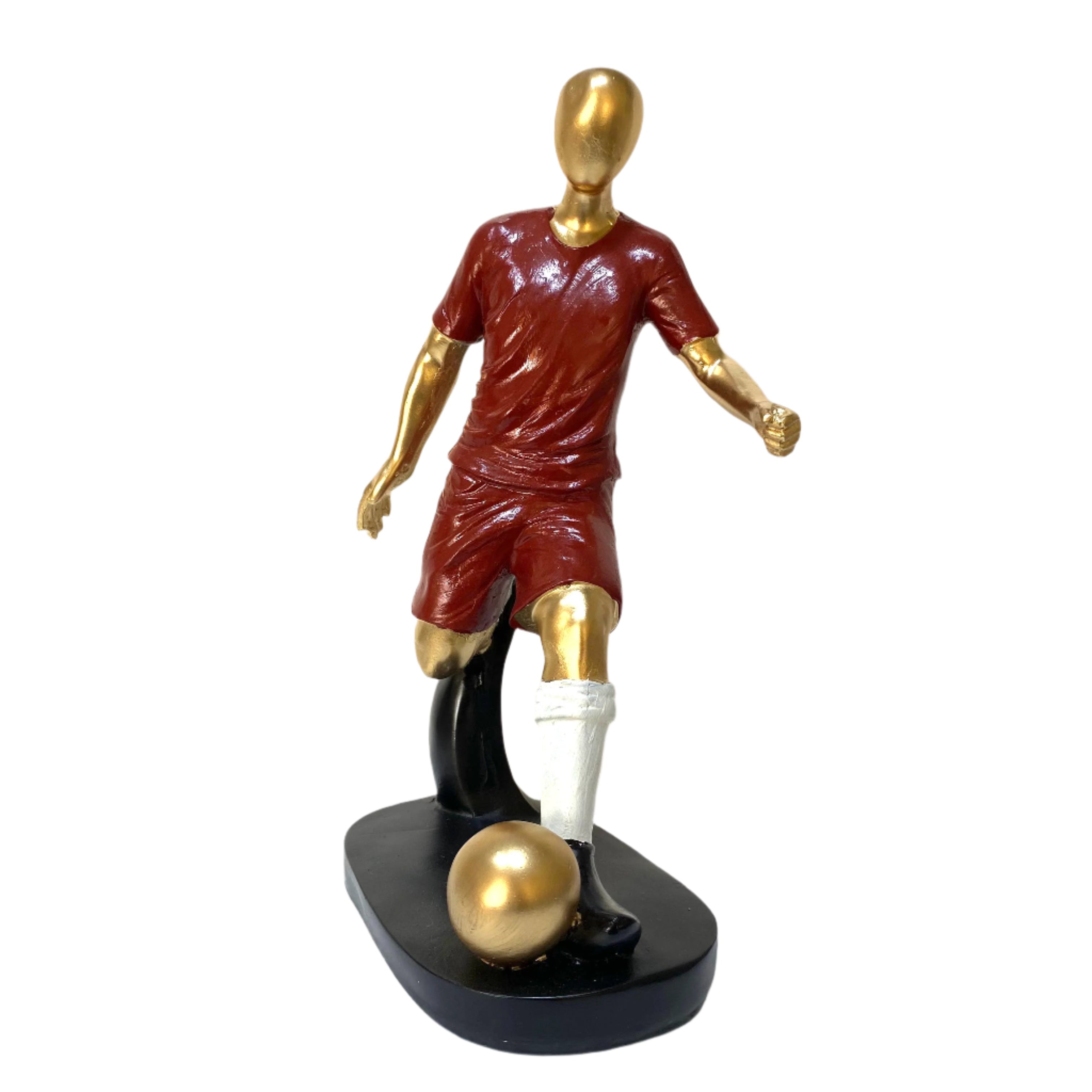 Statue of a soccer player in maroon and gold uniform with a golden soccer ball on a black base.