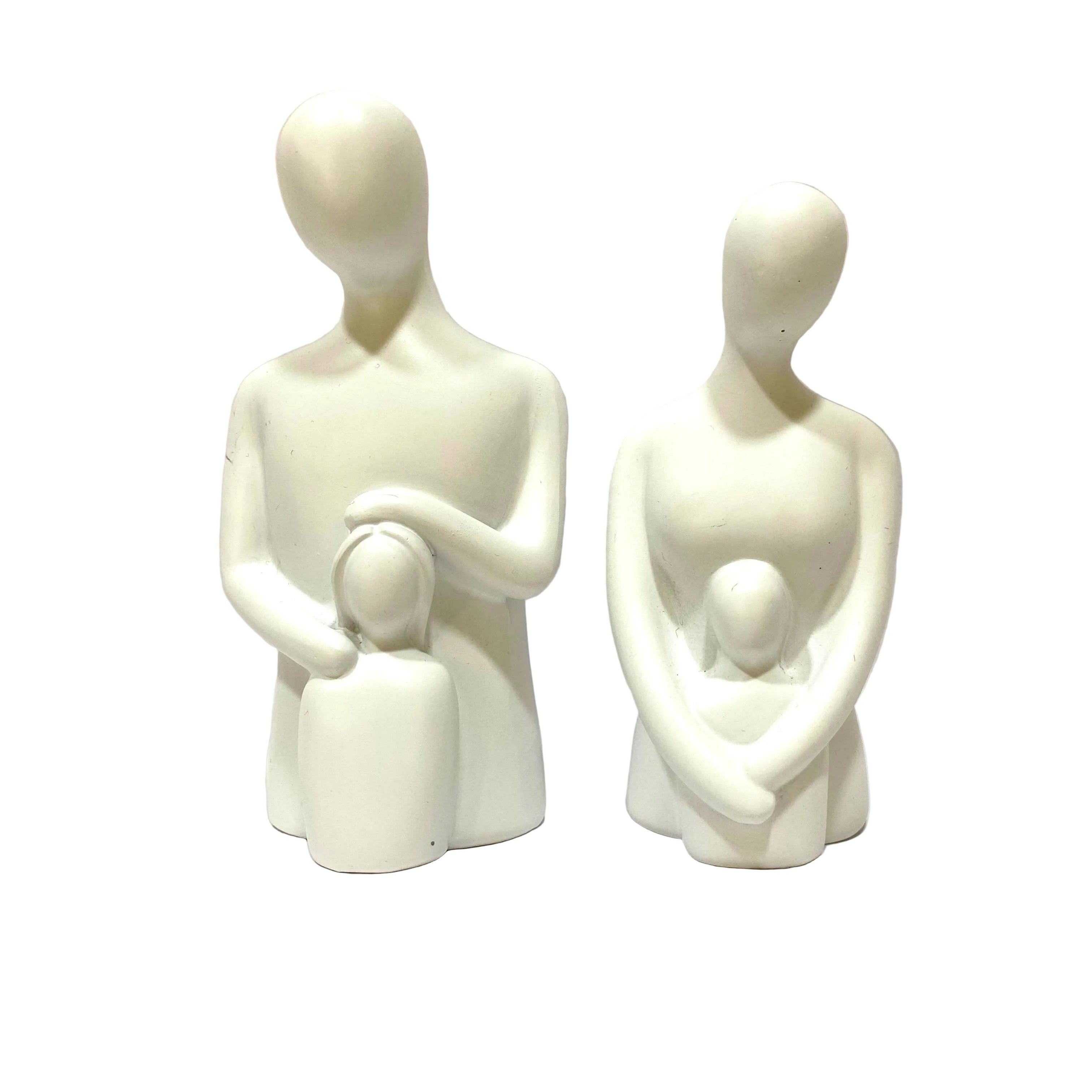 Two white ceramic figures of a family on a light gray background
