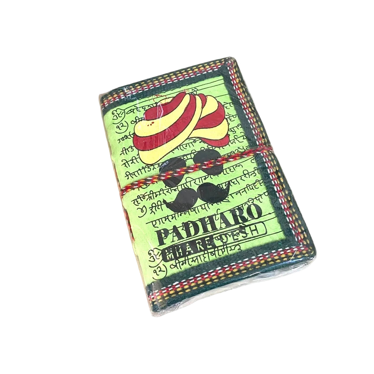 A small packaged product labeled PADHARO PANCHASHRUT located on a light wood tabletop. The package has a light green background with black text, a red-and-yellow striped circular graphic, and black decorative elements, wrapped in clear plastic.