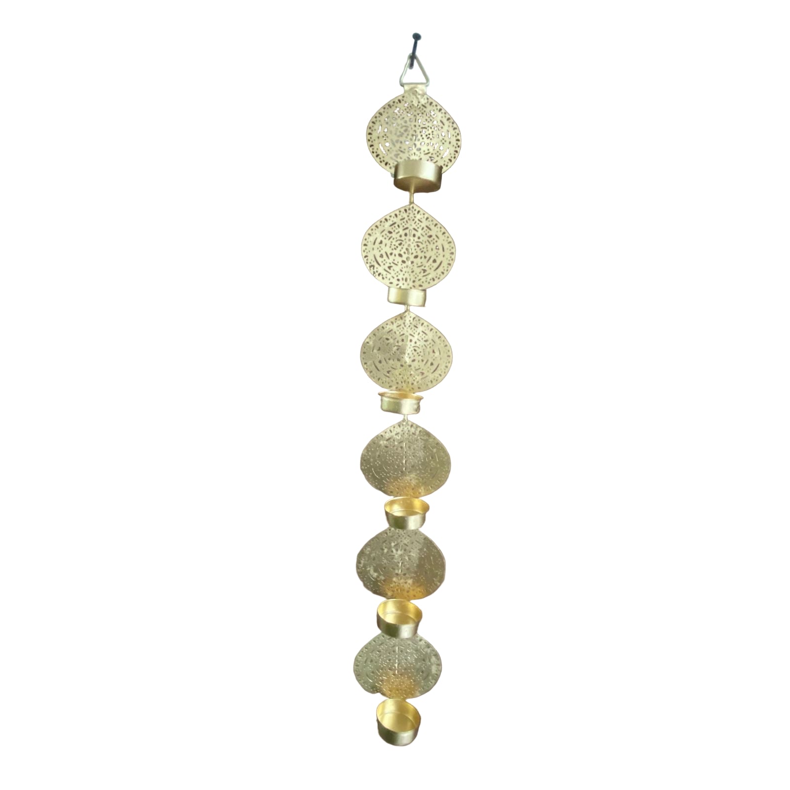 Decorative gold hanging ornament against a wooden door