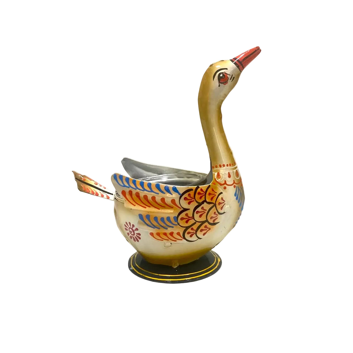 A vintage hand-painted metal swan-shaped container, likely for tea or coffee, featuring a cream-colored body with orange, blue, and red painted patterns, set against a plain, slightly worn background.