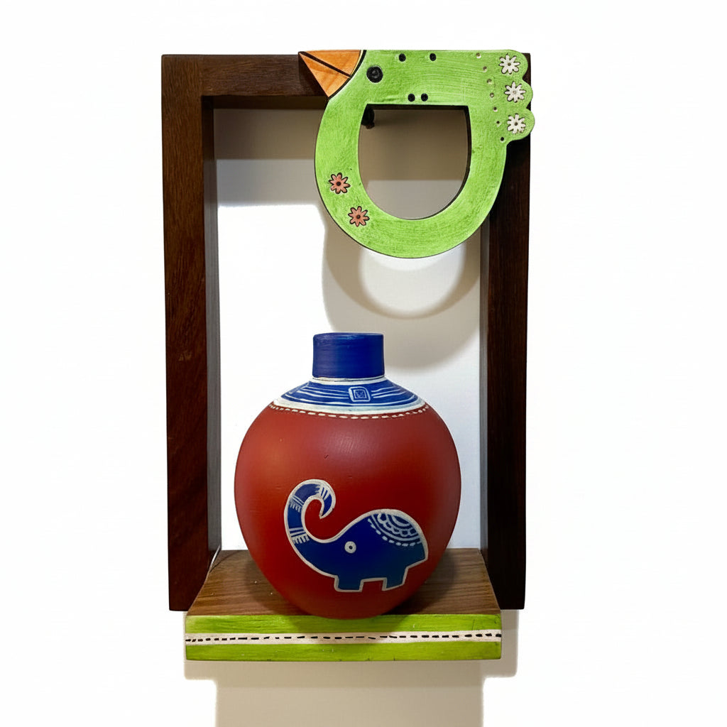 Decorative pot with elephant design in a wooden box against a textured white background