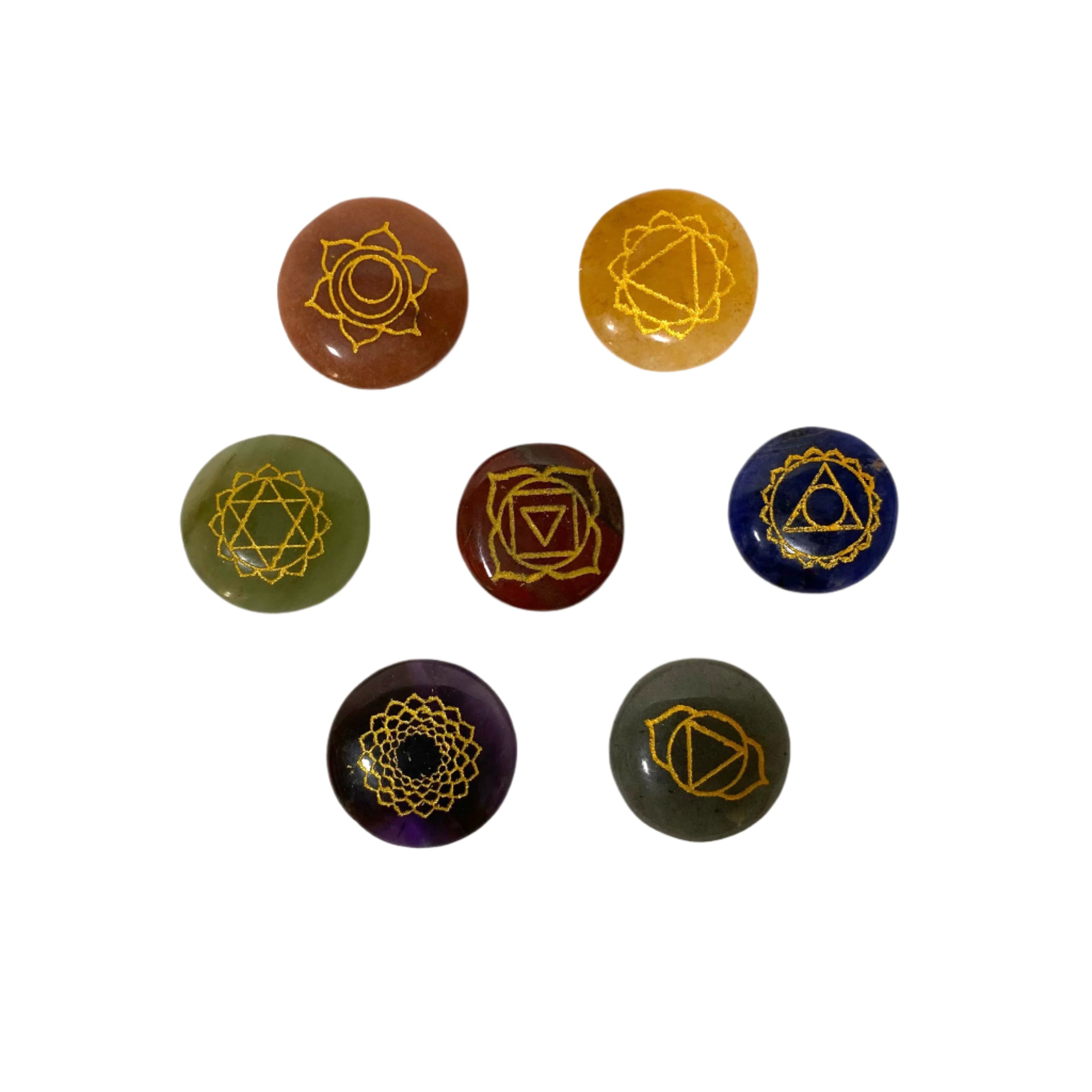 Set of seven chakra stones with symbolic designs on a white background