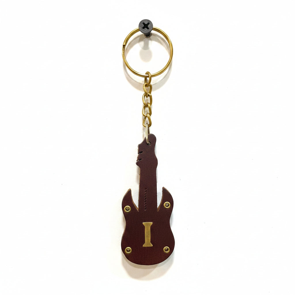 Guitar-shaped keychain on a textured white background