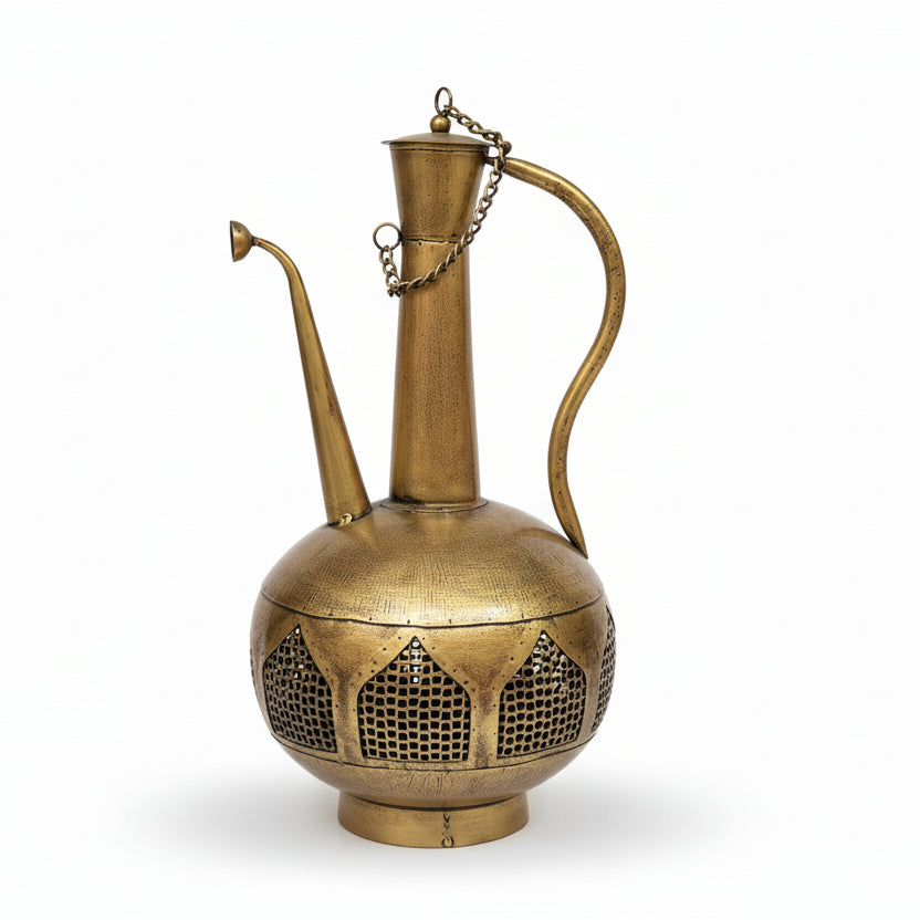 Brass lamp with intricate design on a white surface, with a store interior in the background.