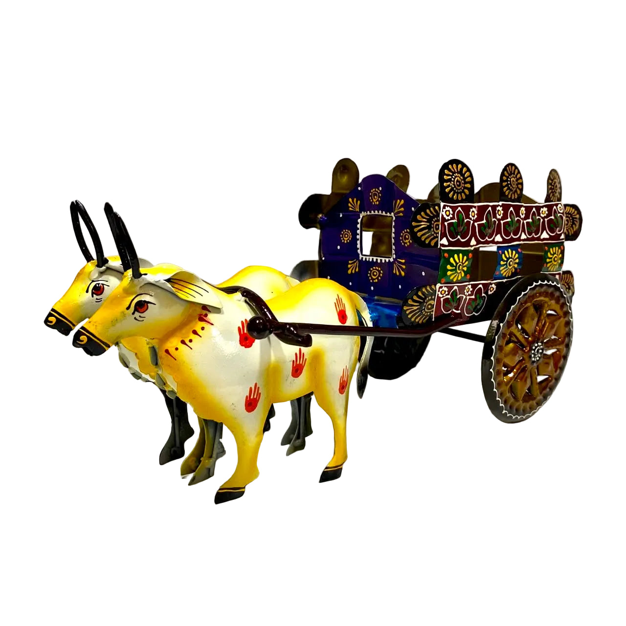 A decorative toy or model of a traditional pulled cart with two yellow and white oxen, set against a plain white wall and floor.