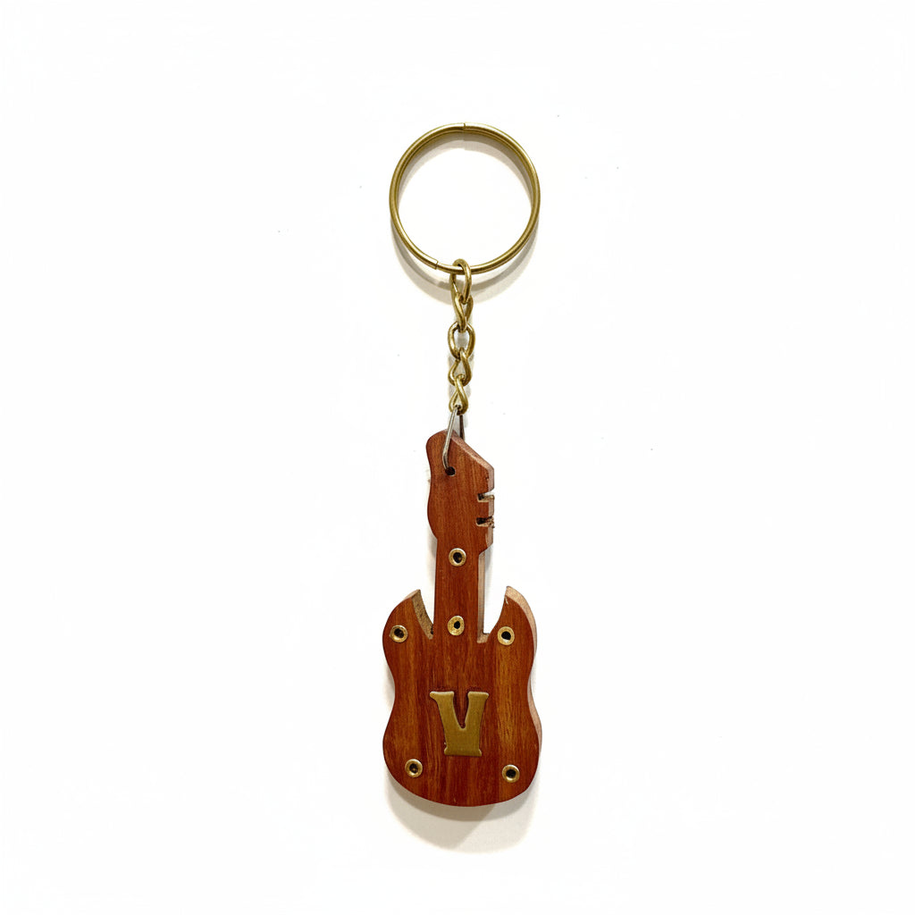 Guitar-shaped keychain on a textured white background