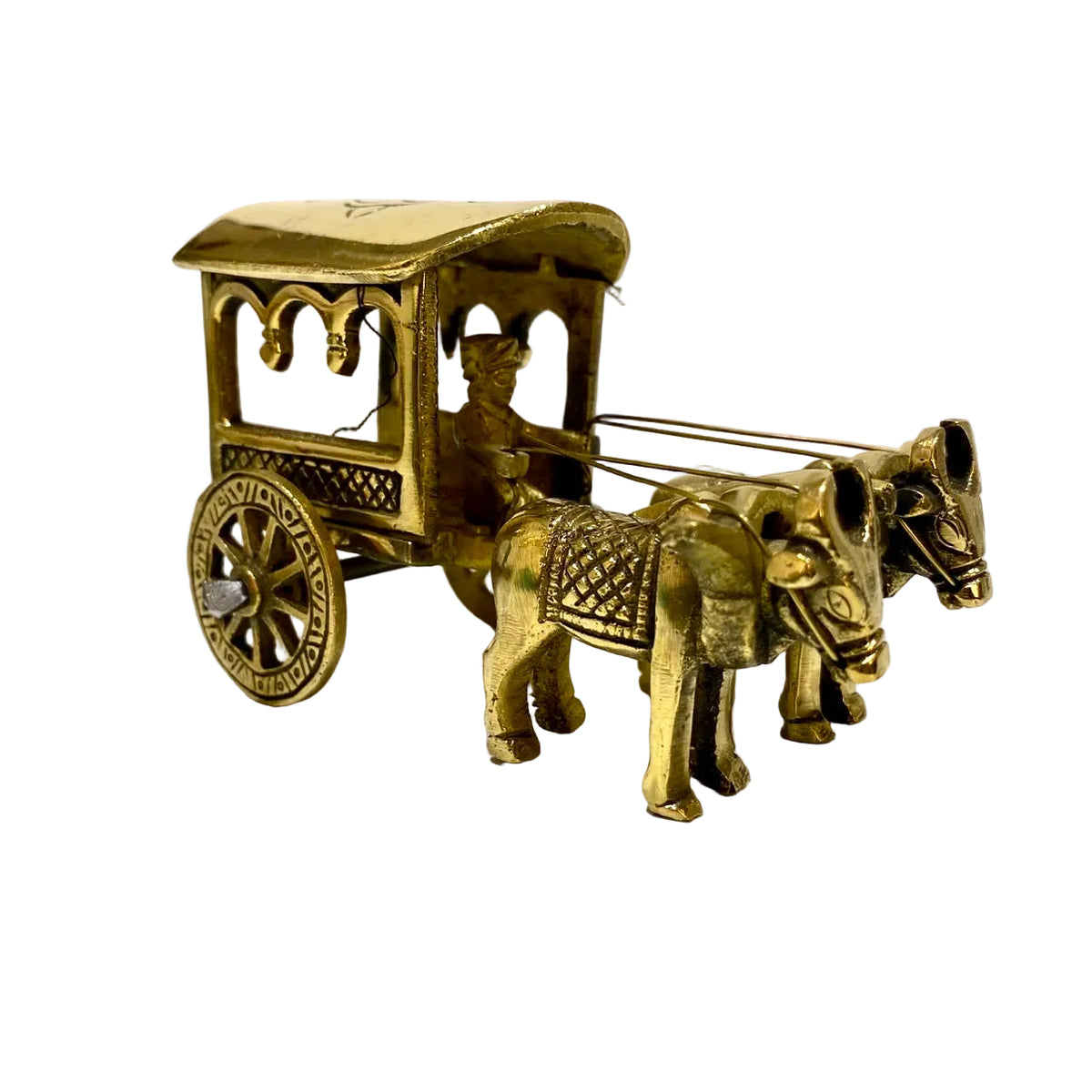 A small brass carriage figurine with two horses and a driver, photographed on a white surface against a plain light background.