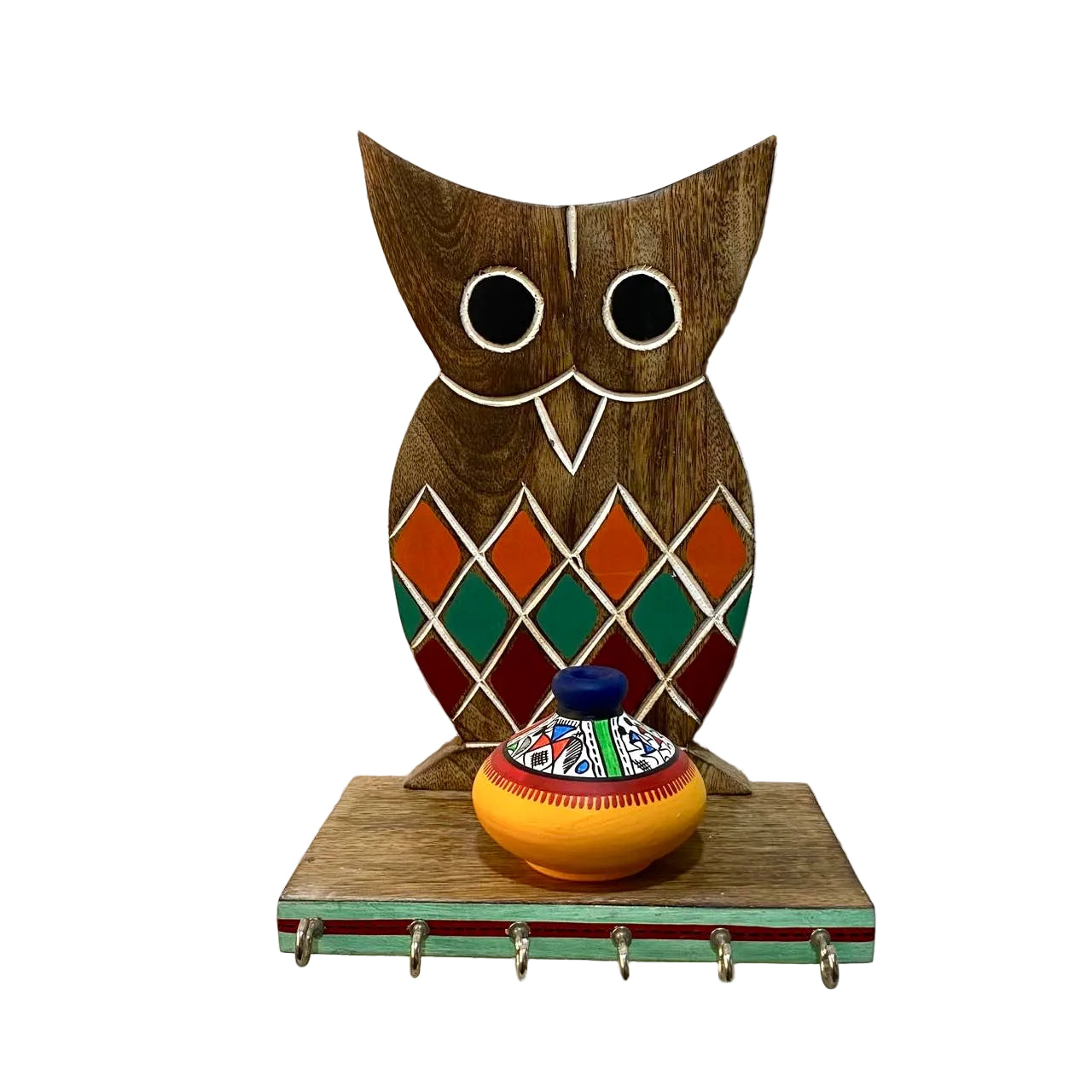 Wooden owl shelf with colorful pot on a textured white wall