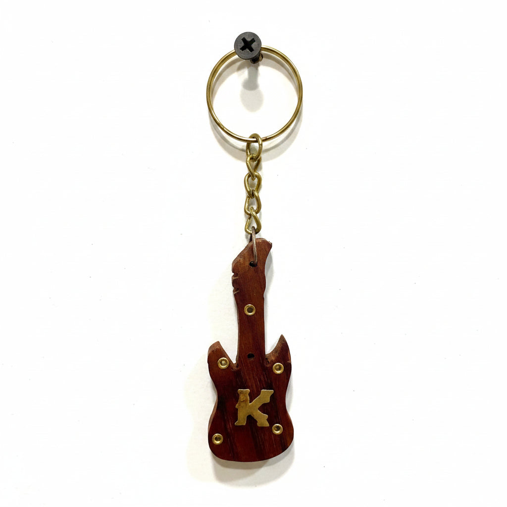 Guitar-shaped keychain with 'K' on a textured white background