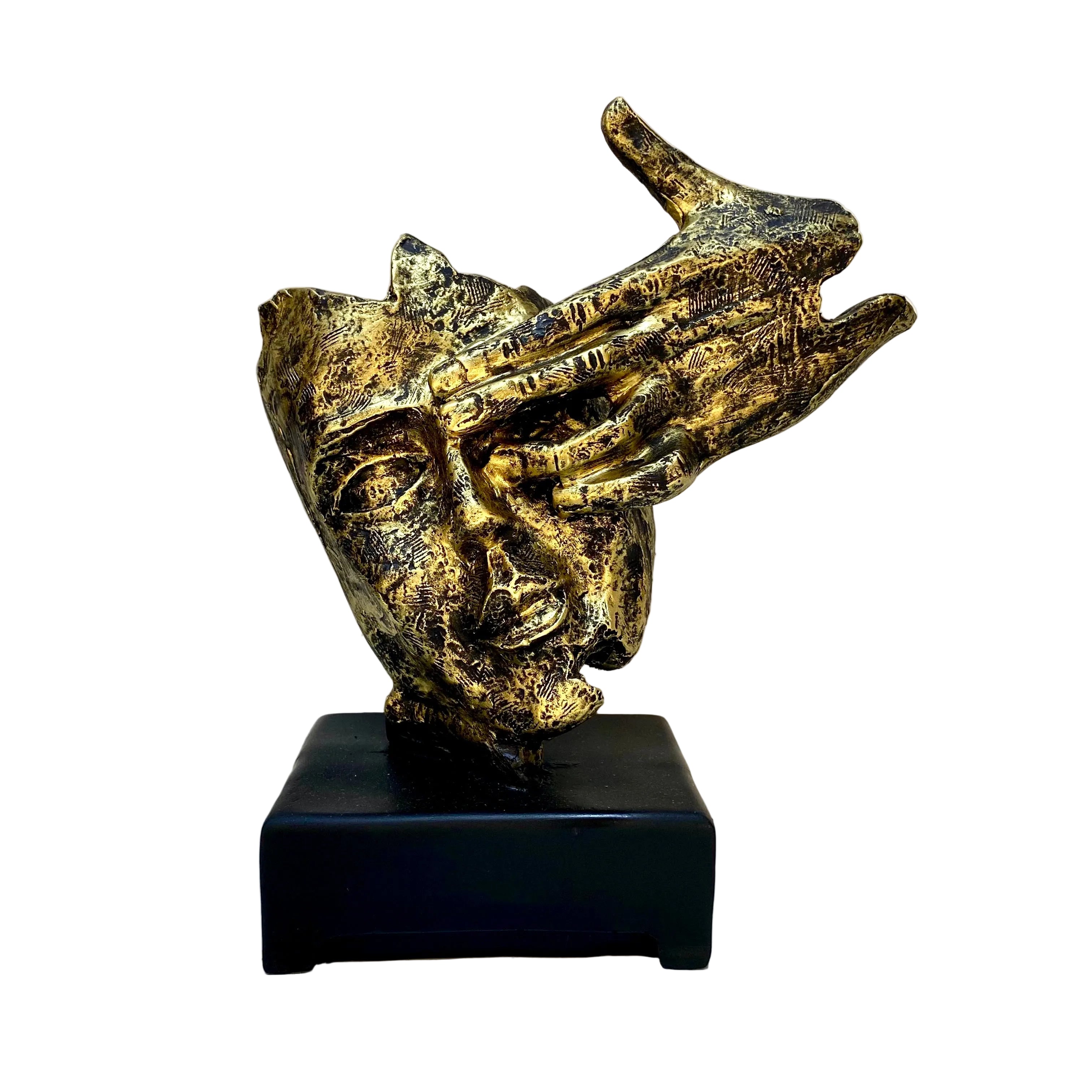 Bronze sculpture of a face with a hand on a black base against a white wall.