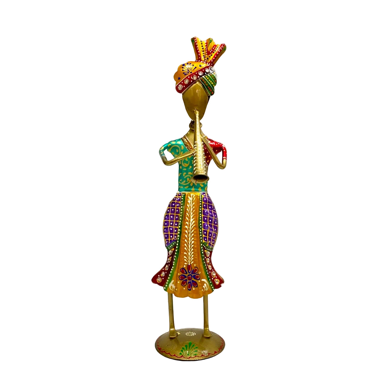 A decorative brass figurine of a dancing musician playing a flute, adorned with colorful painted patterns in green, purple, red, and gold, standing on a round base against a white wall.