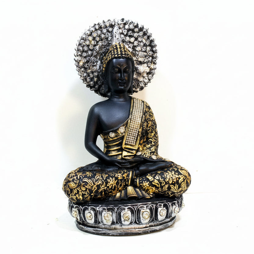 Decorative statue of a seated figure with intricate detailing on a plain background