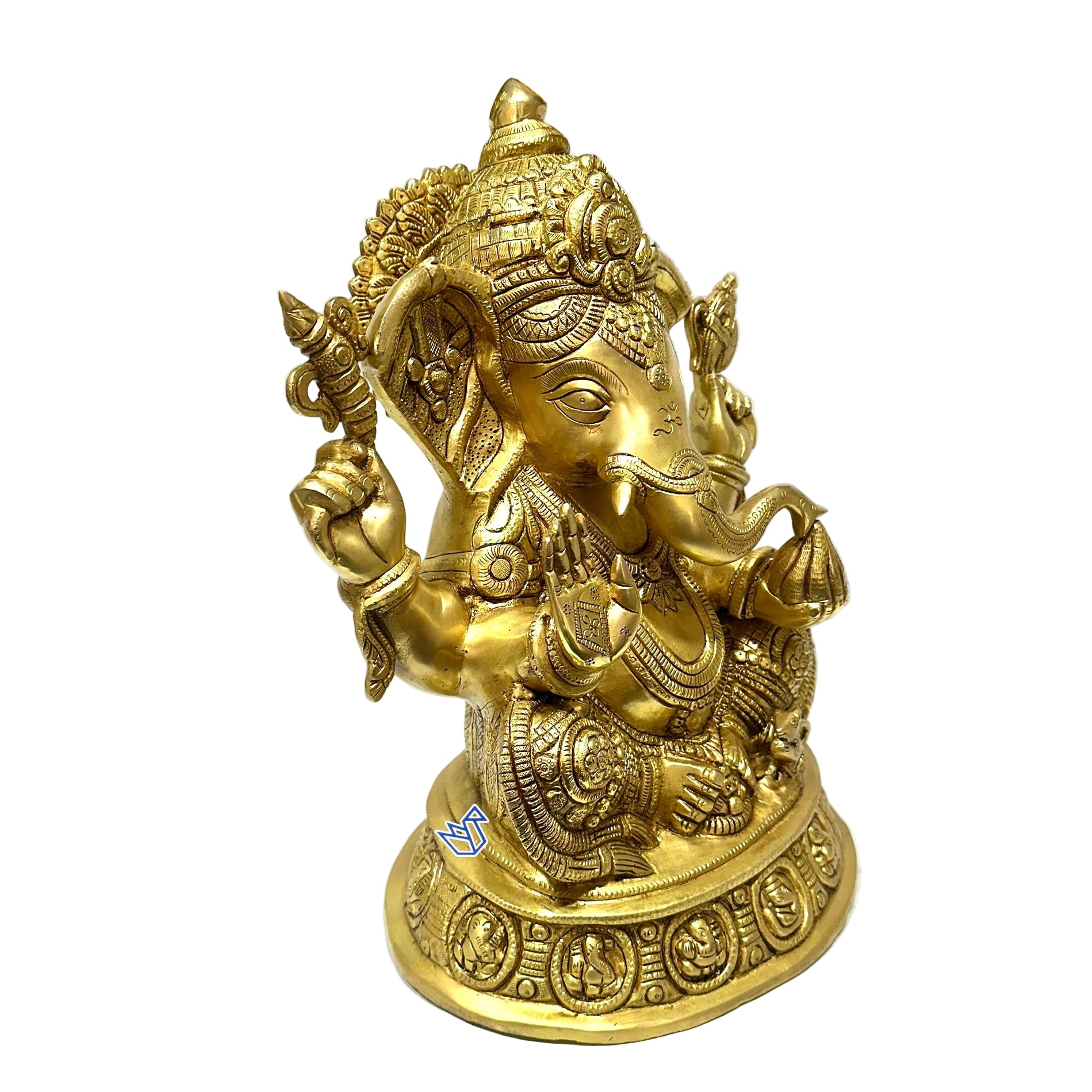 Gold-colored Ganesha statue on a white surface with blurred background