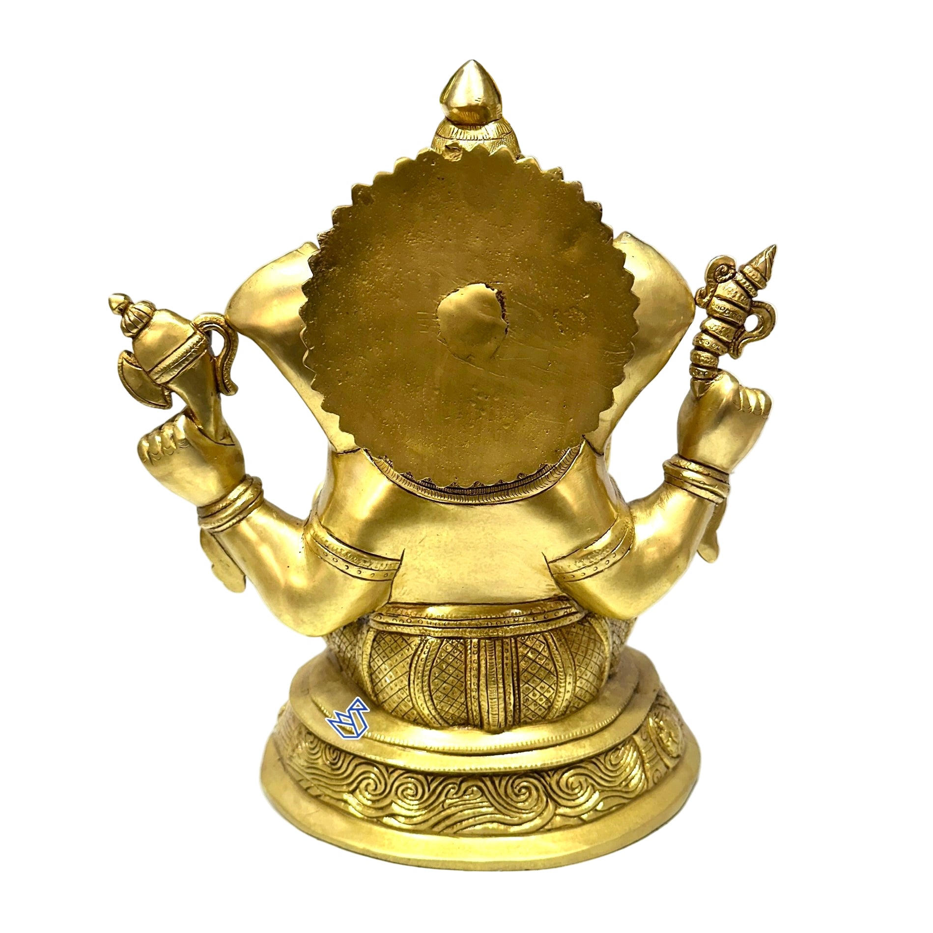 Gold-colored deity statue on a white surface with blurred background