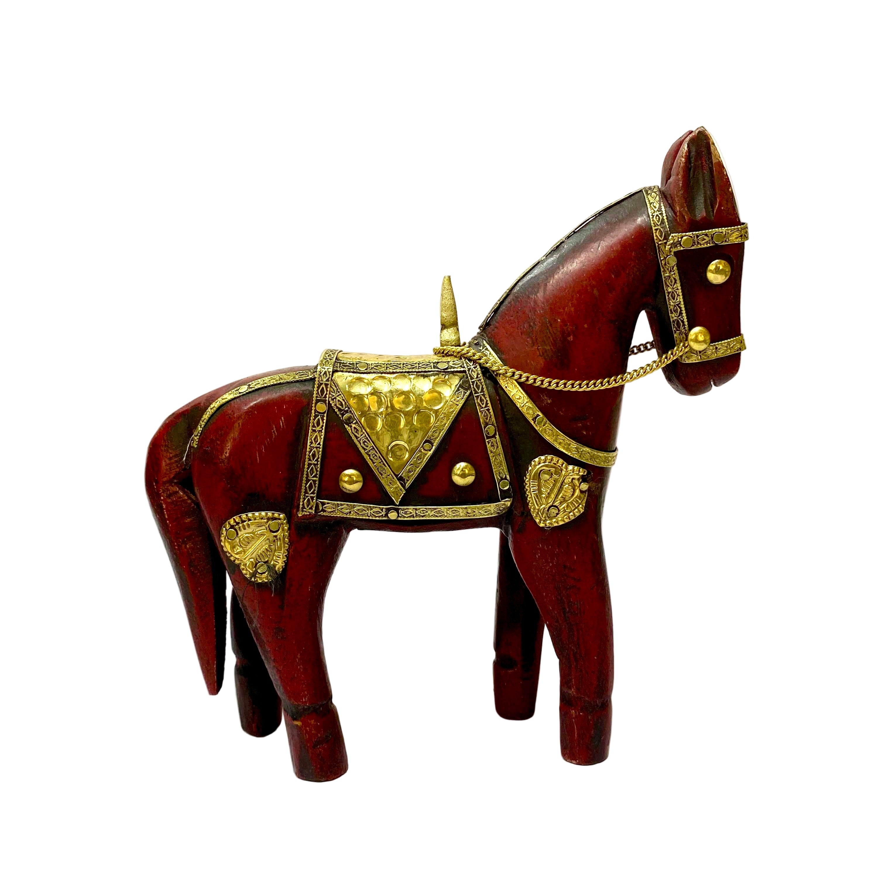 Decorative wooden horse figurine with gold accents on a white background