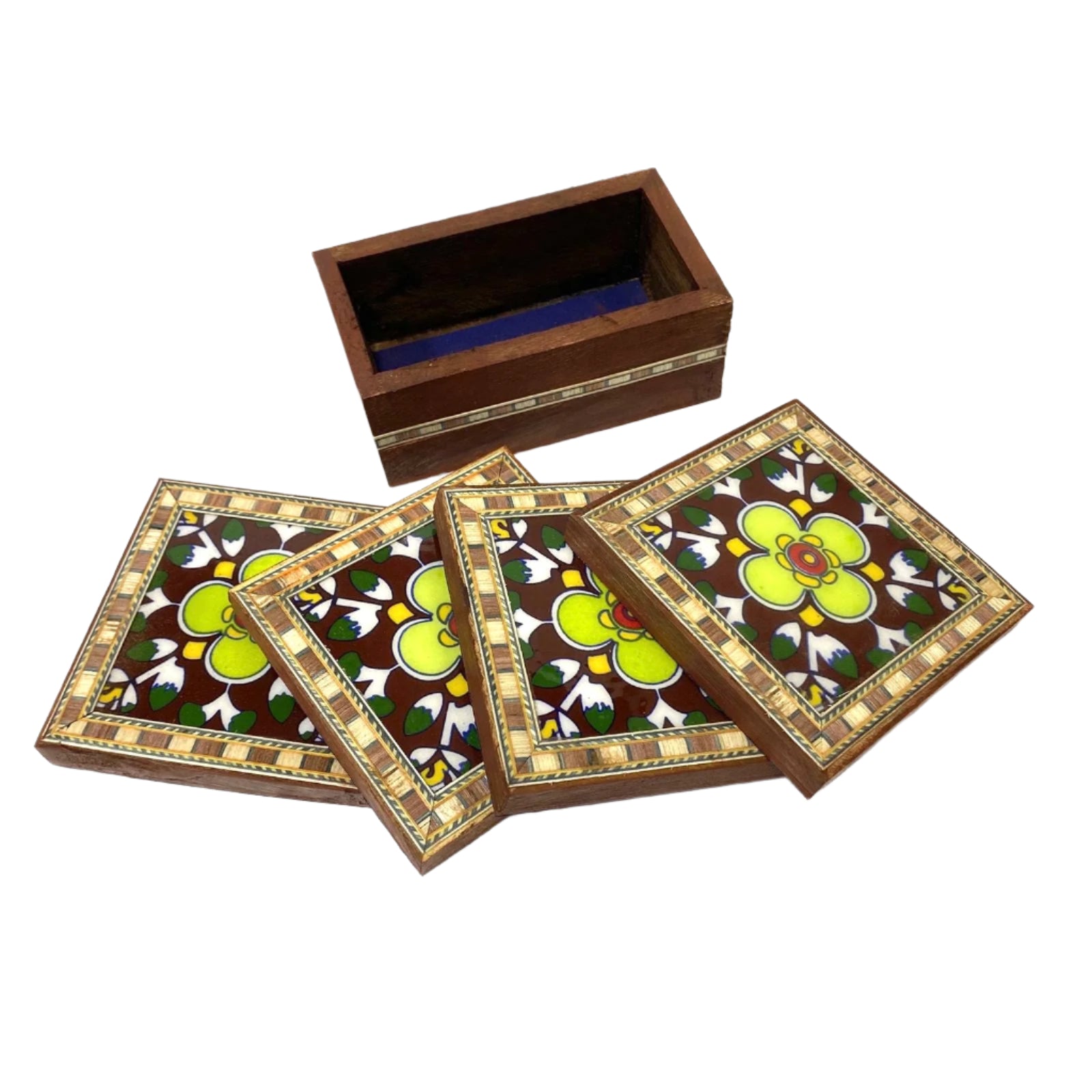 Set of four decorative coasters with floral design on a wooden box.