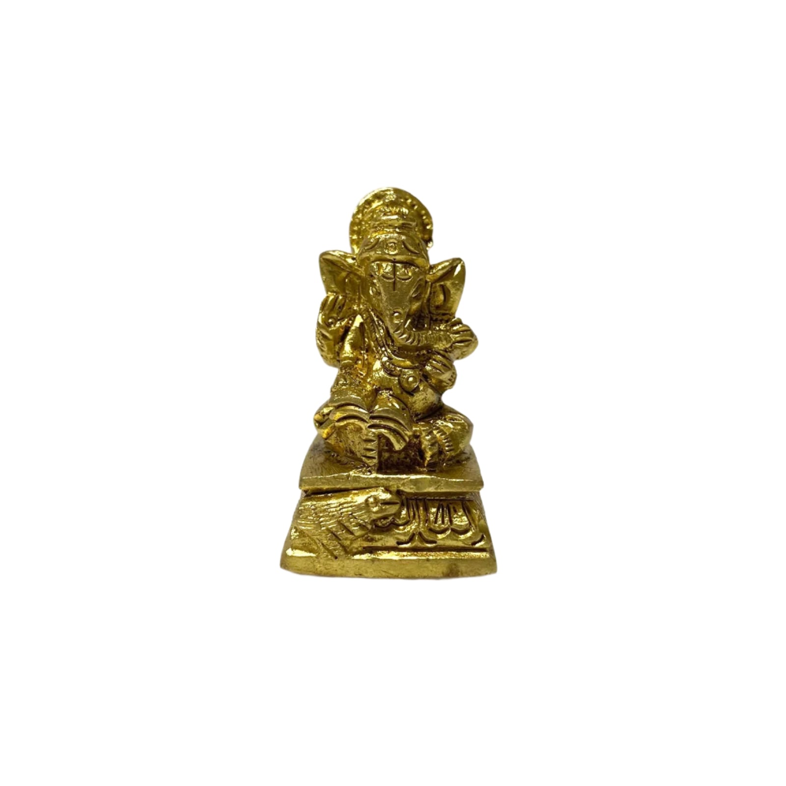 Small brass statue of a deity on a white textured surface