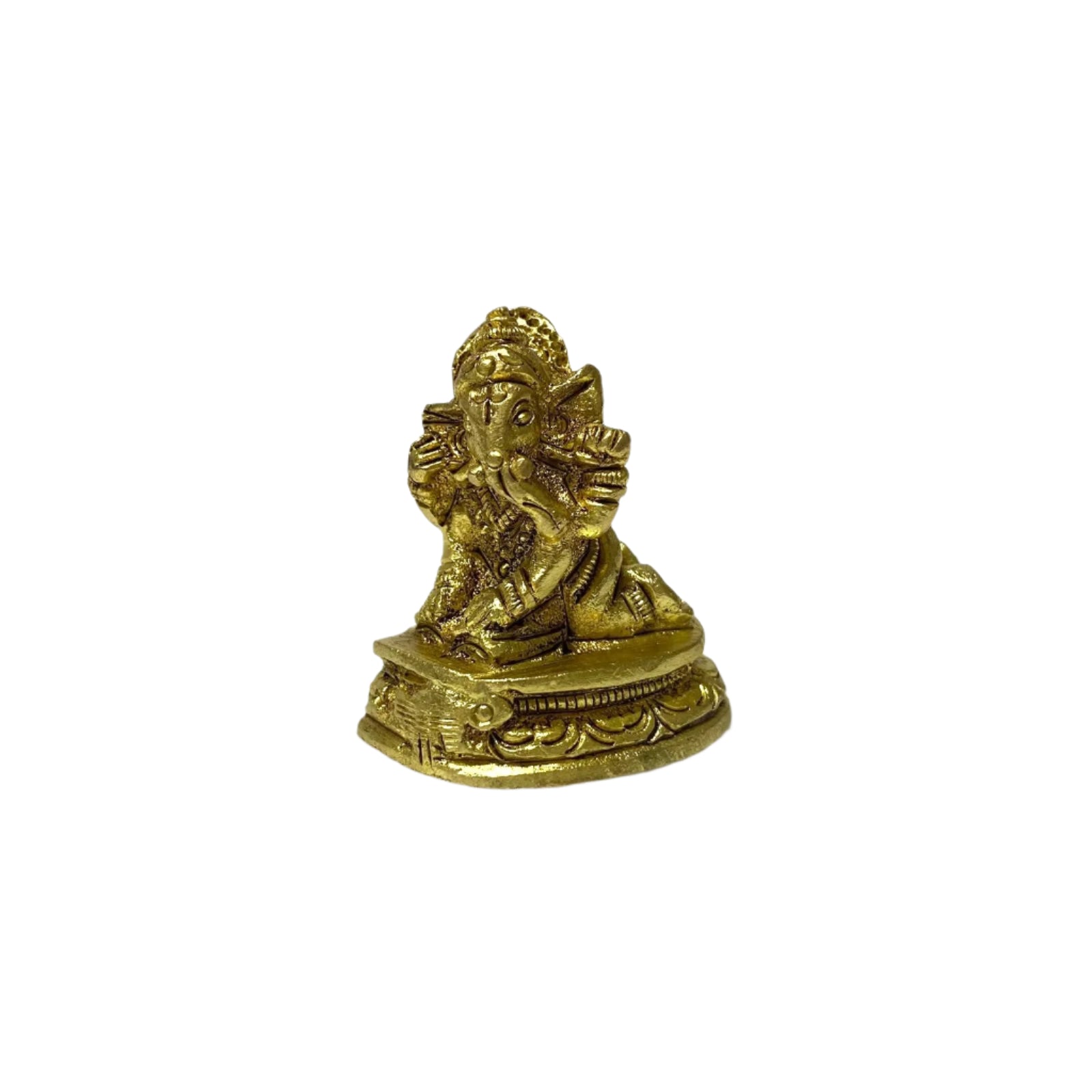 Brass statue of a deity on a white textured surface