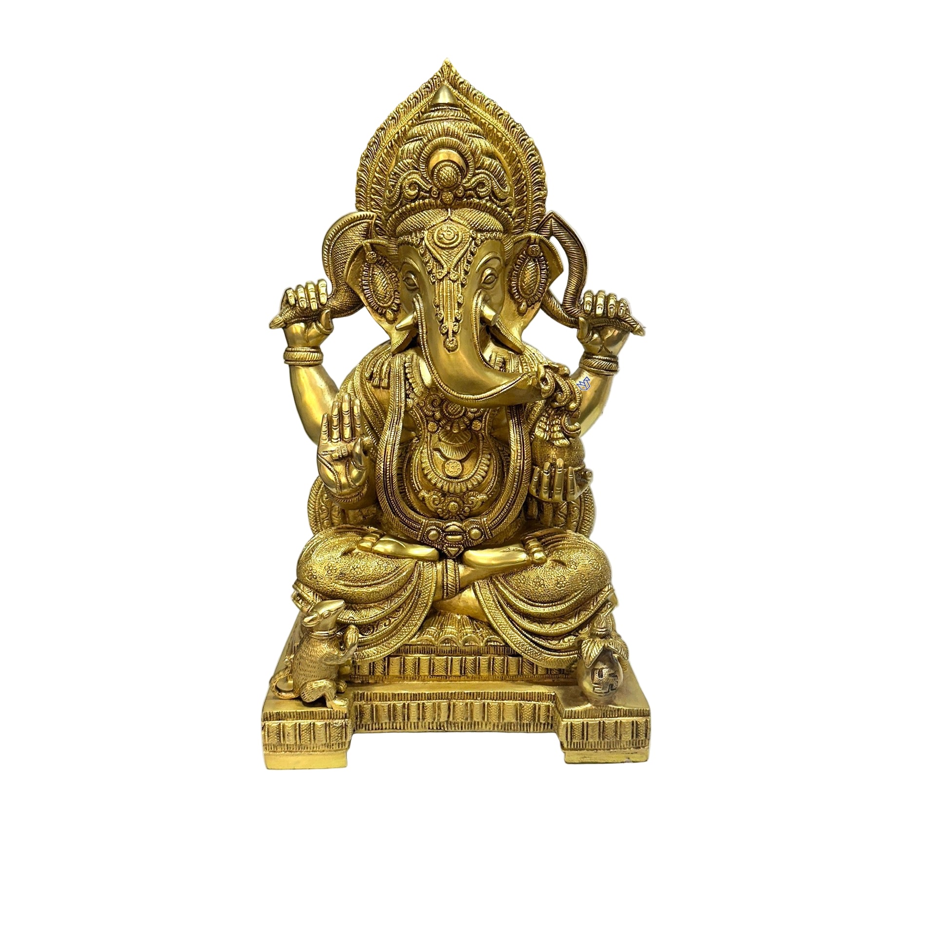 Gold-colored statue of a deity on a white surface with a blurred background