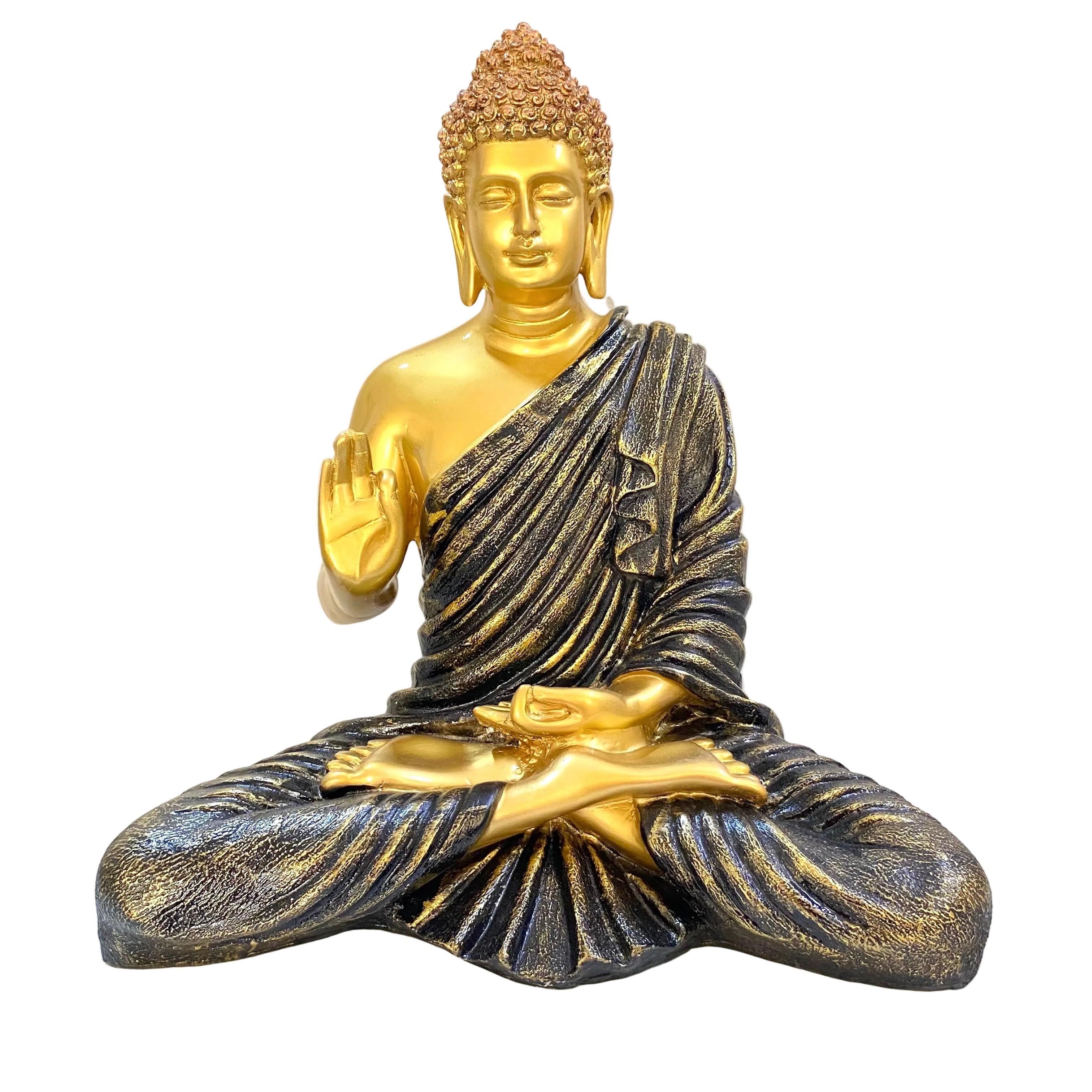 Gold and bronze Buddha statue on a white surface with a document in the background