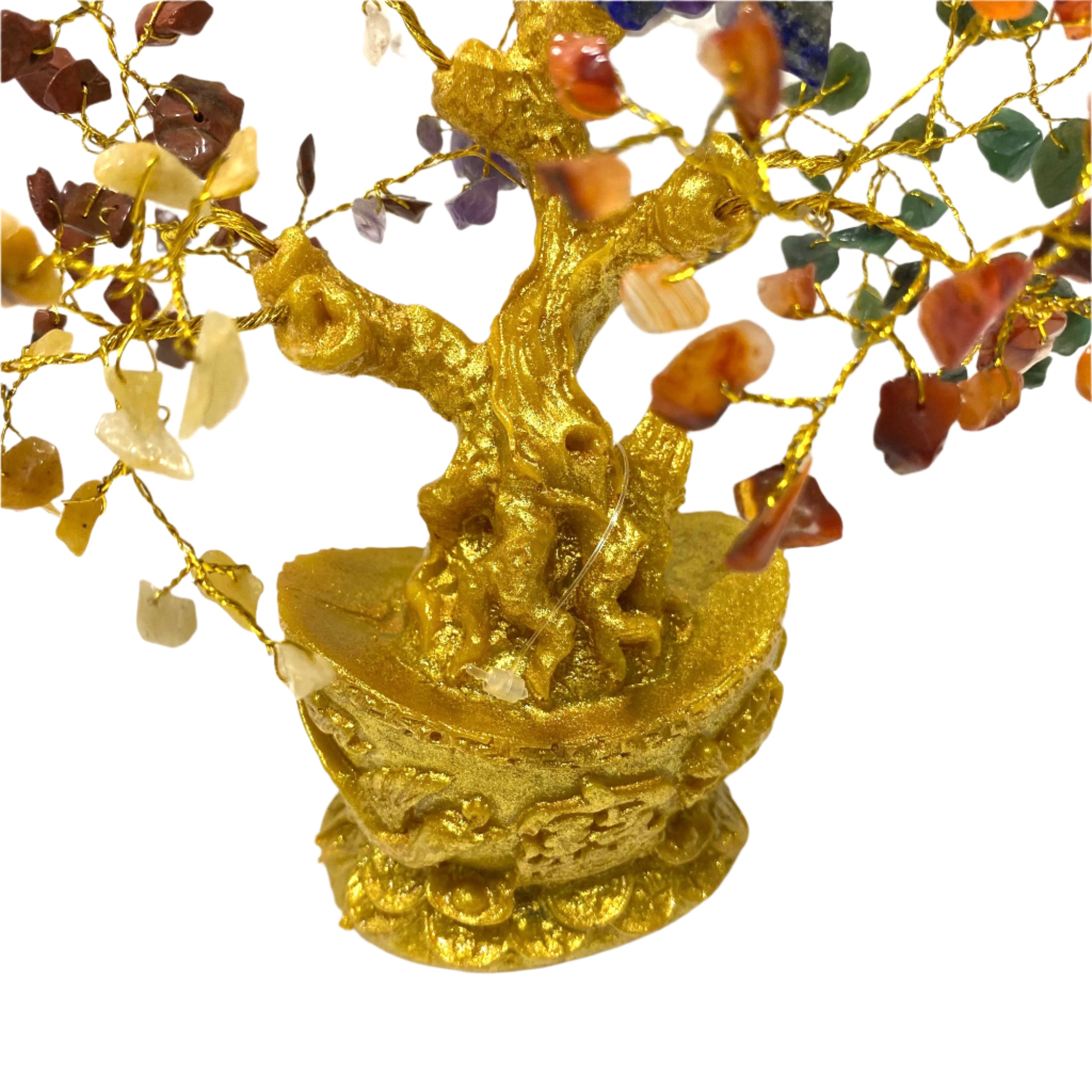 Decorative gold tree with multicolored stones on a white background