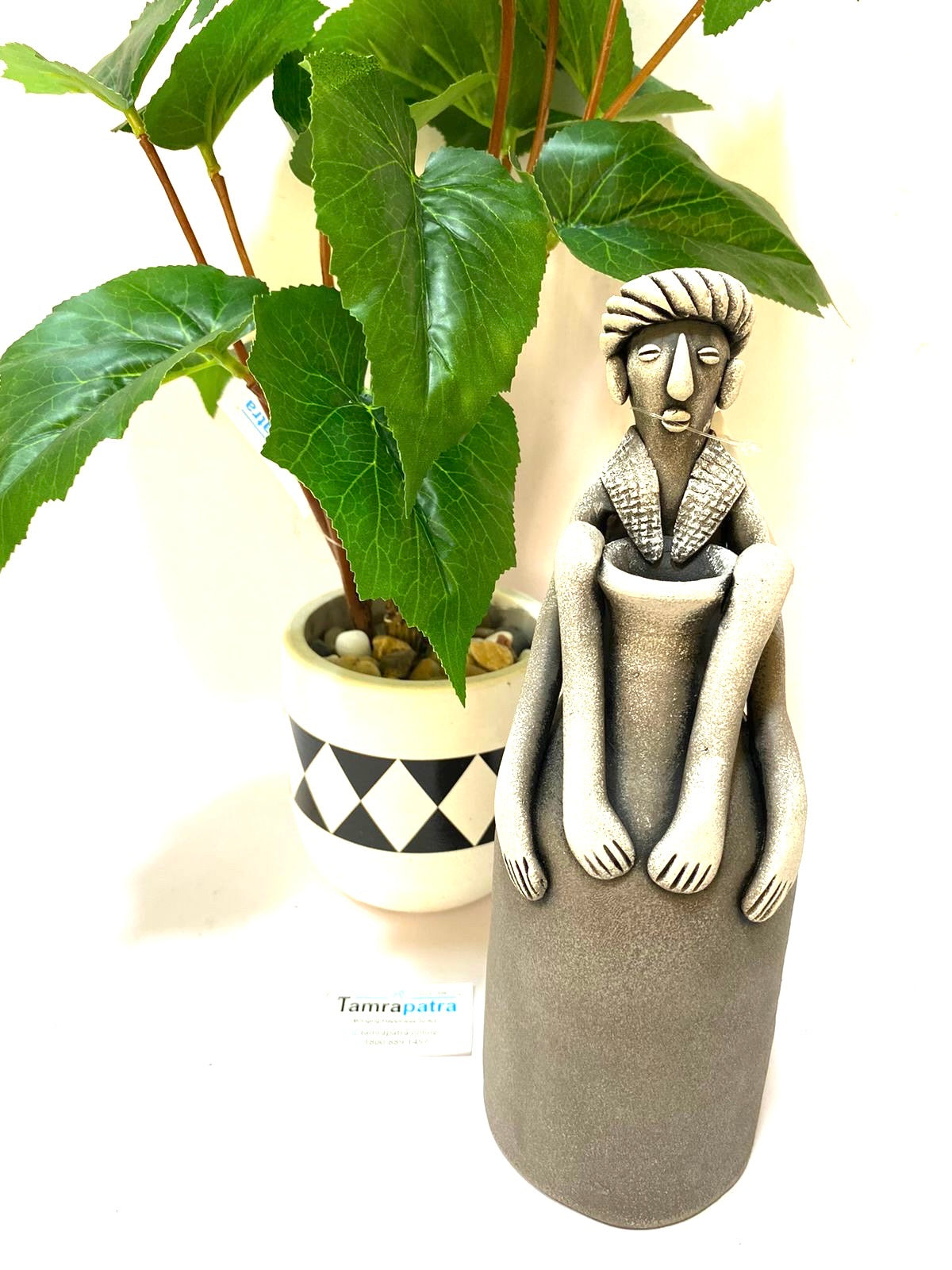 Tribal Man Sitting on Colorful Pot Exclusive Pottery Decoration By Tamrapatra