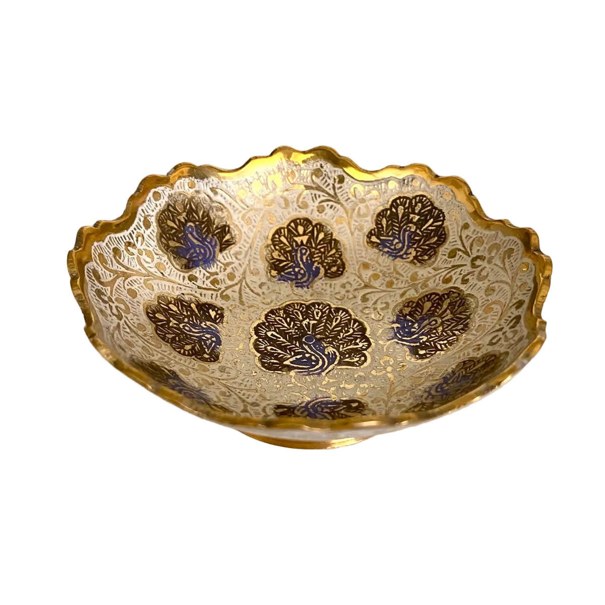 A scalloped ceramic bowl with a gold and white embossed floral pattern and blue accents, photographed on a light-colored surface.