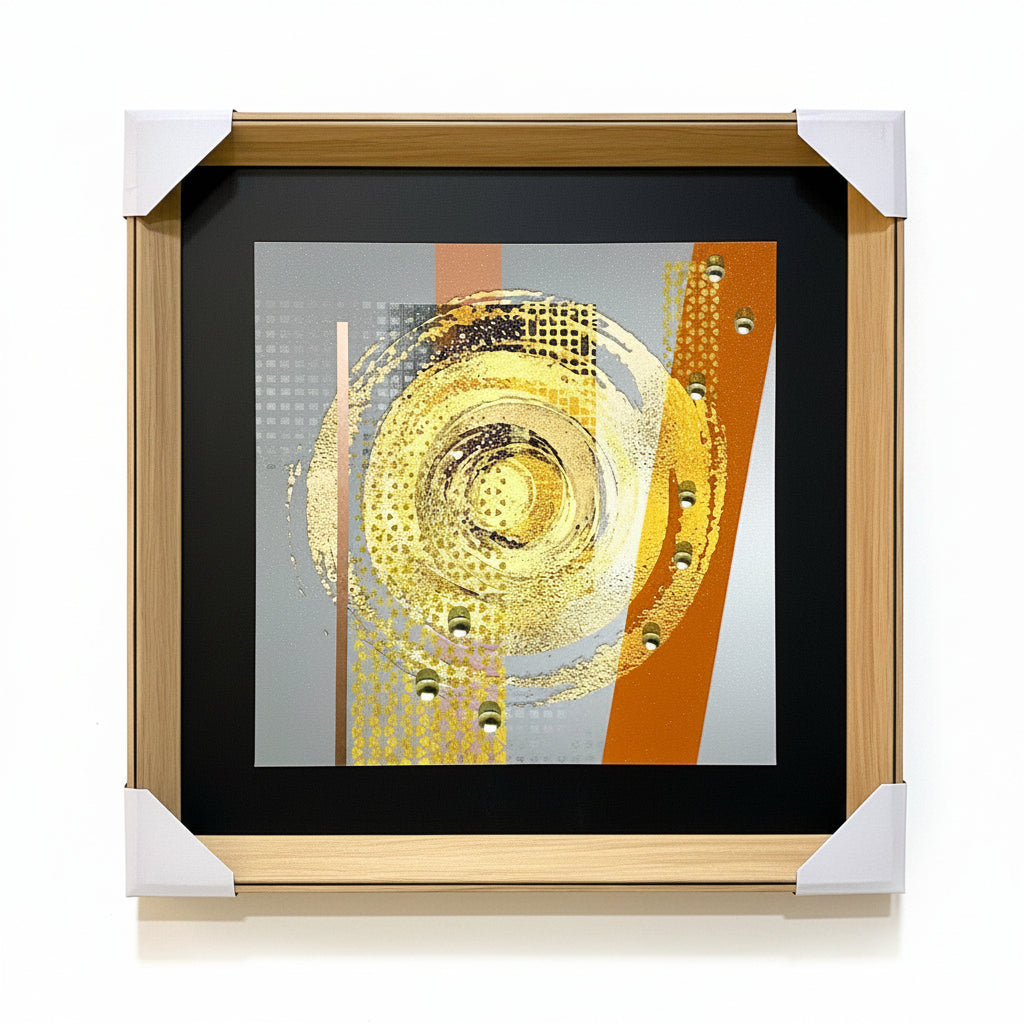 Framed abstract artwork with gold and orange elements on a textured wall.