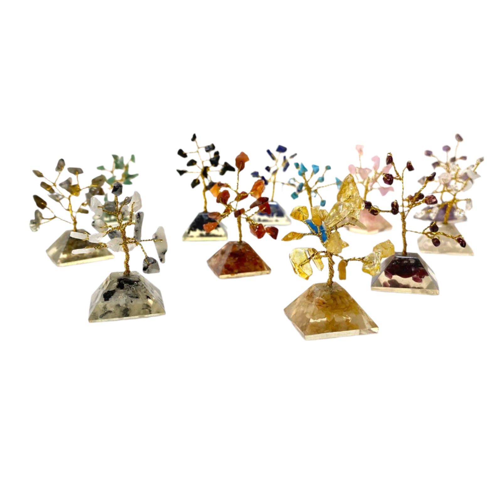 Set of small crystal trees on clear stands against a white background