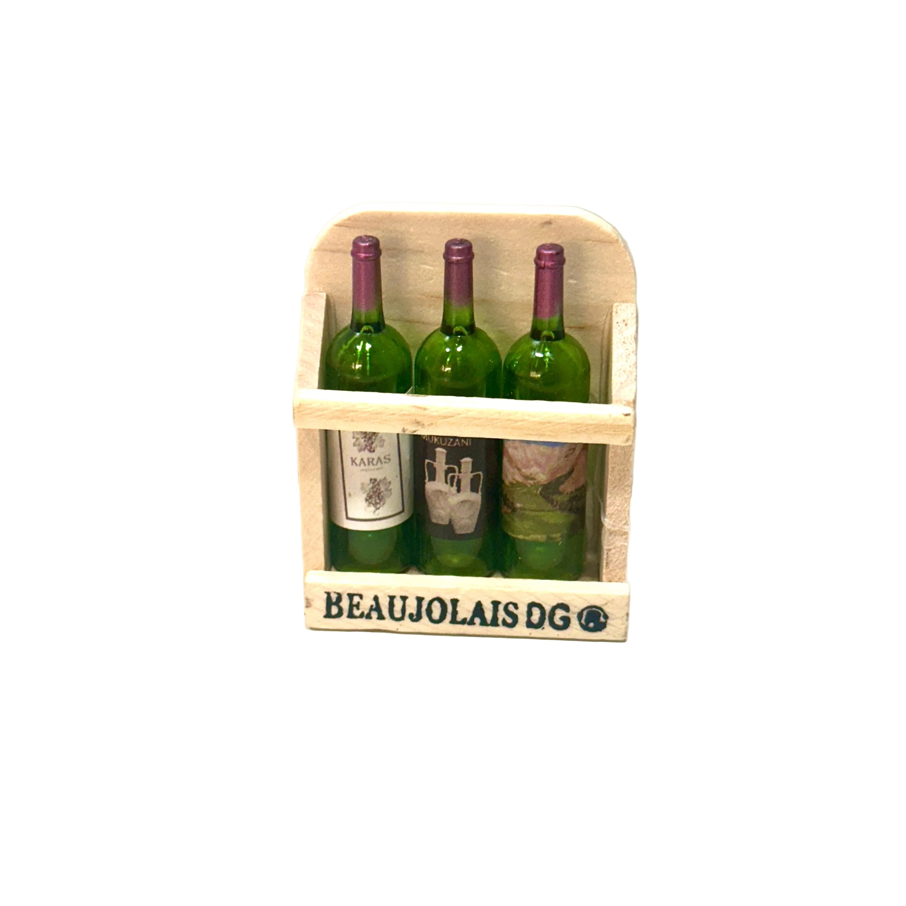 Three bottles of Beaujolais wine in a wooden crate on a white surface.