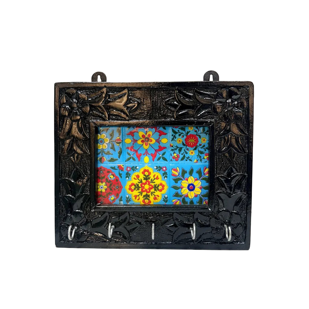 Decorative wall hook with floral tile design and black ornate frame.