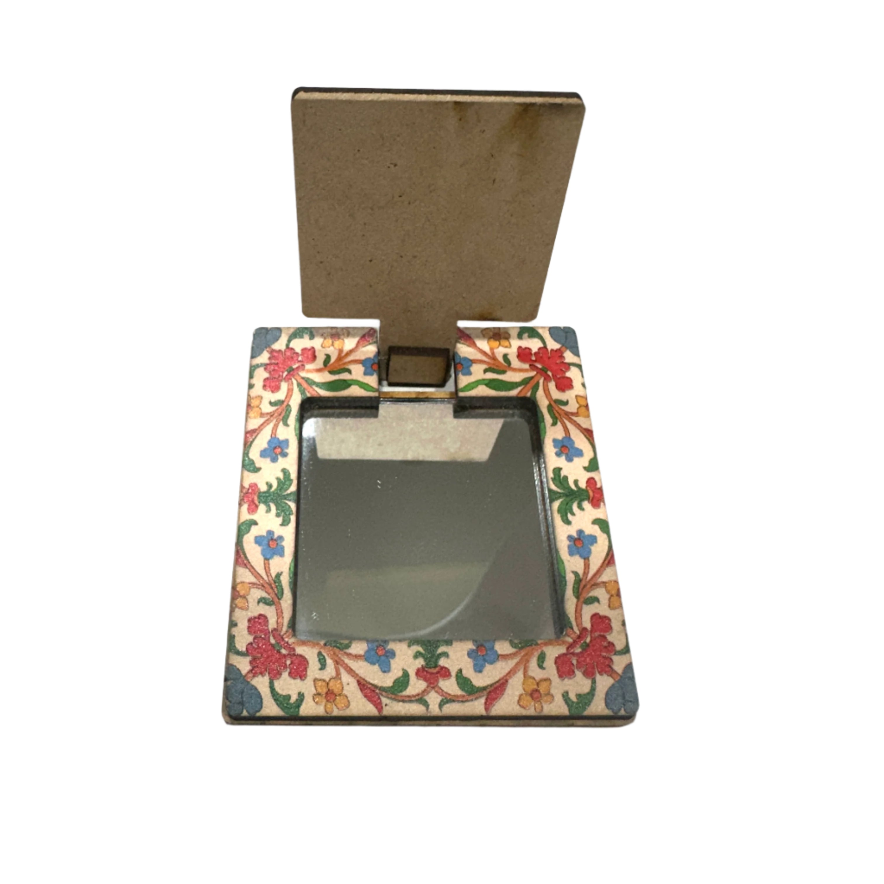 Decorative compact mirror with floral design on a white surface