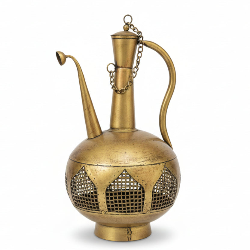Brass ewer with intricate designs on a white surface in a store setting