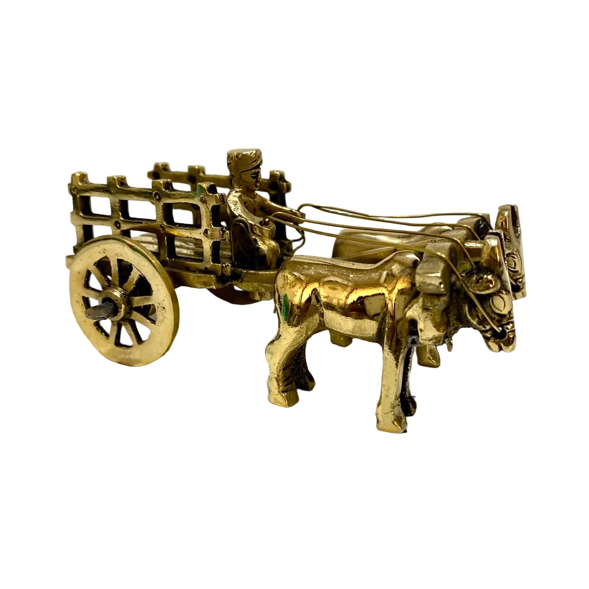 A small brass-colored decorative miniature cart with a driver and two oxen, photographed on a plain light background.