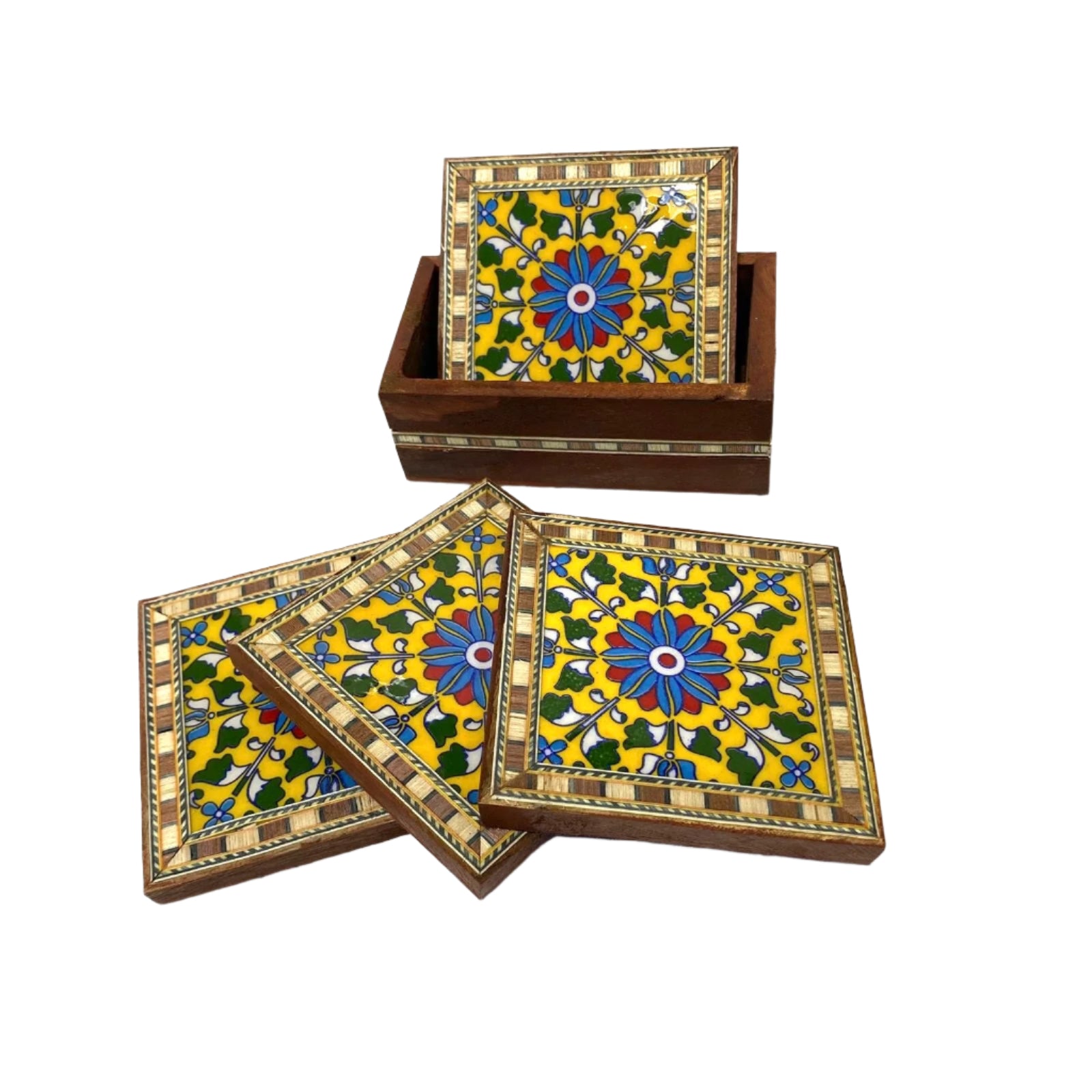 Set of four decorative coasters with a floral design in a wooden box on a white background