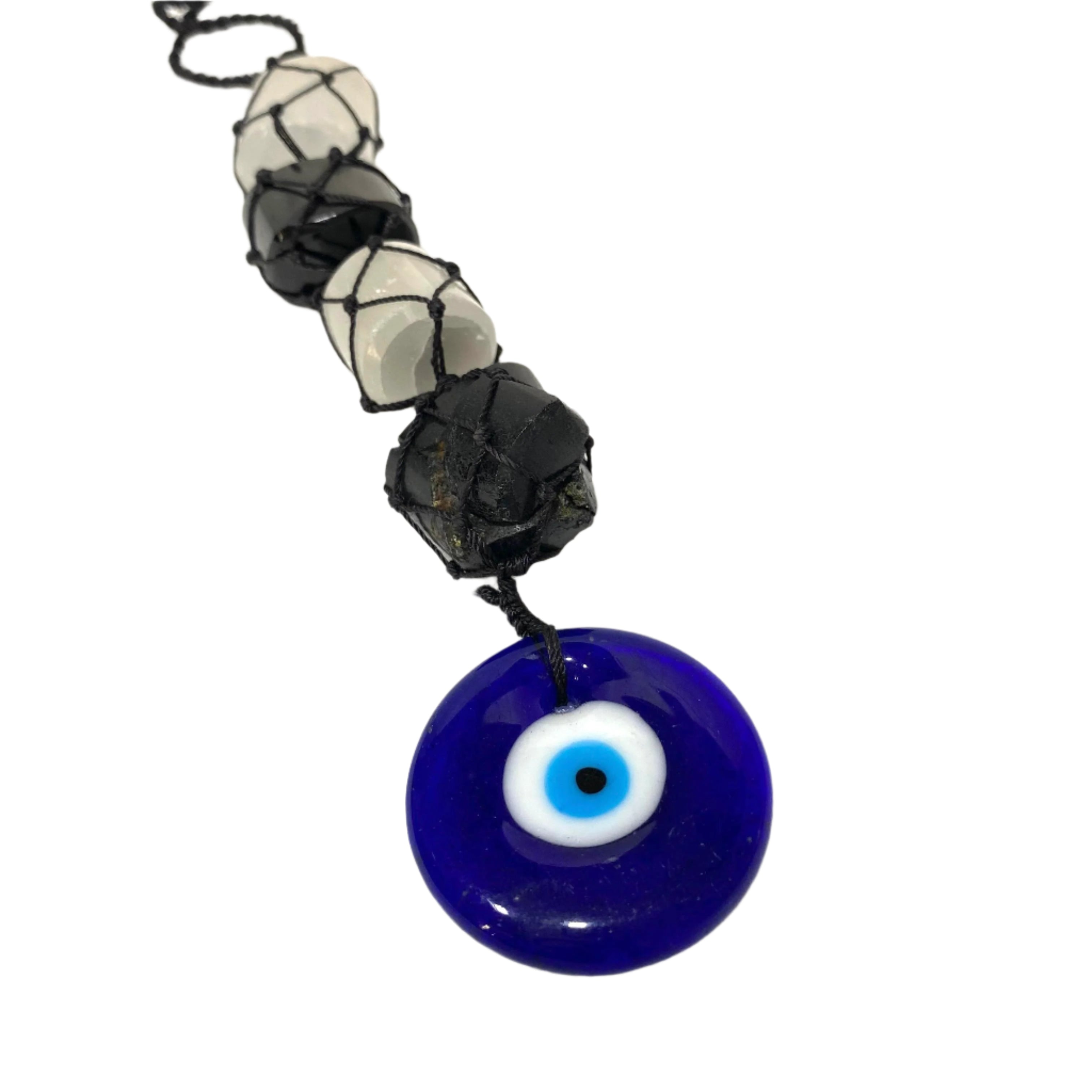 Necklace with a blue evil eye pendant and black and white beads on a white background