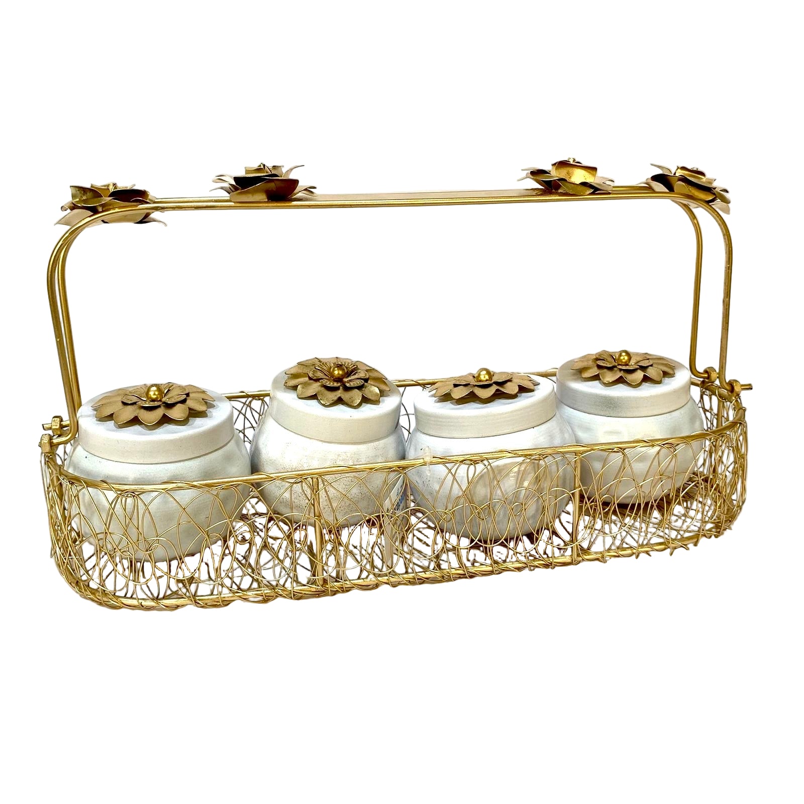 Decorative gold basket with white jars and gold lids on a white background