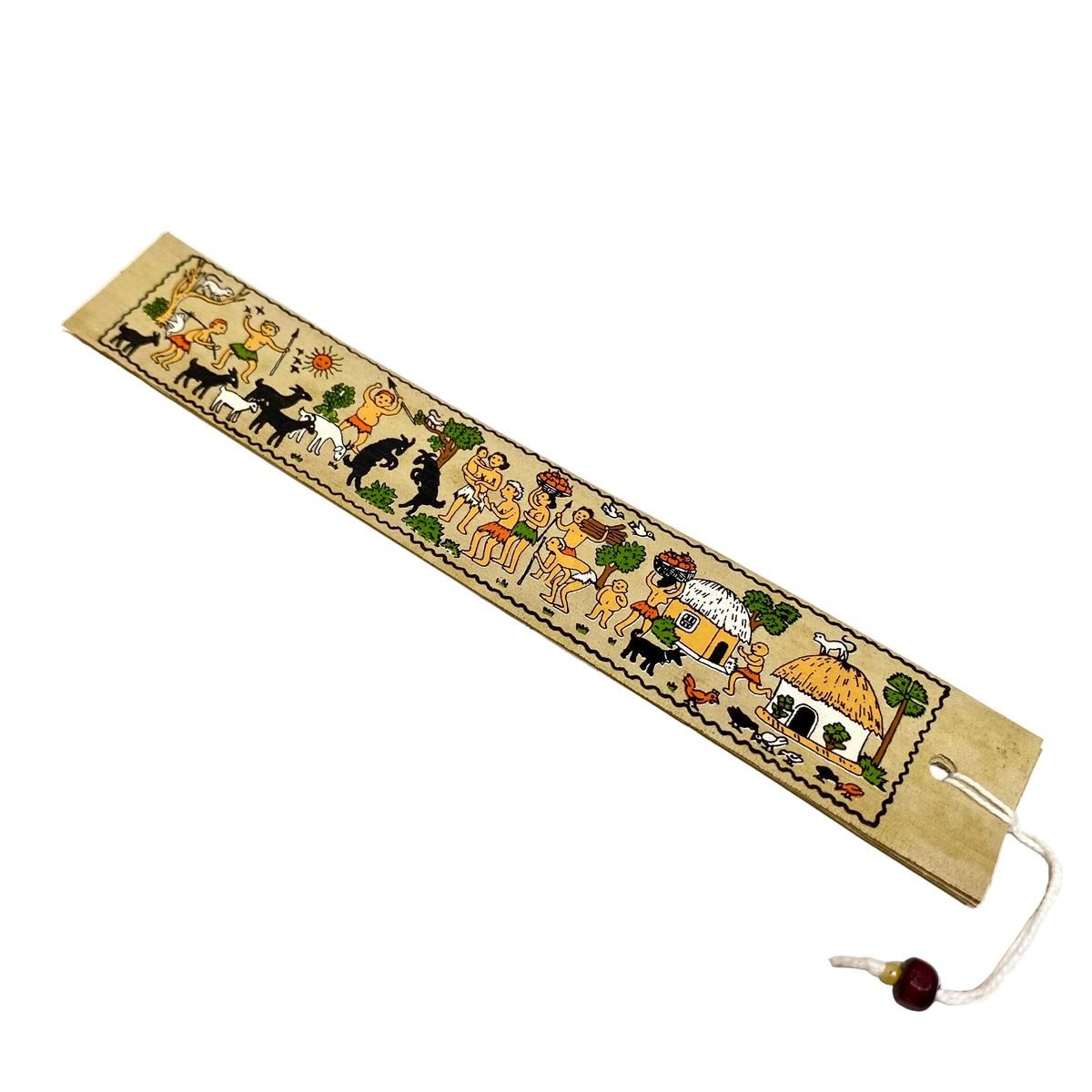 A handmade paper mezuzah case with hand-painted Hebrew letters and illustrations of the Ten Commandments, featuring a white hanging cord with a small dark bead, photographed on a light off-white surface.